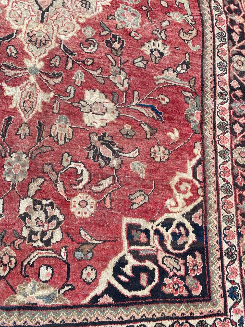 Beautiful Mahal rug with a floral central medallion design and beautiful colors with a red field, entirely hand knotted with wool velvet on cotton foundation.