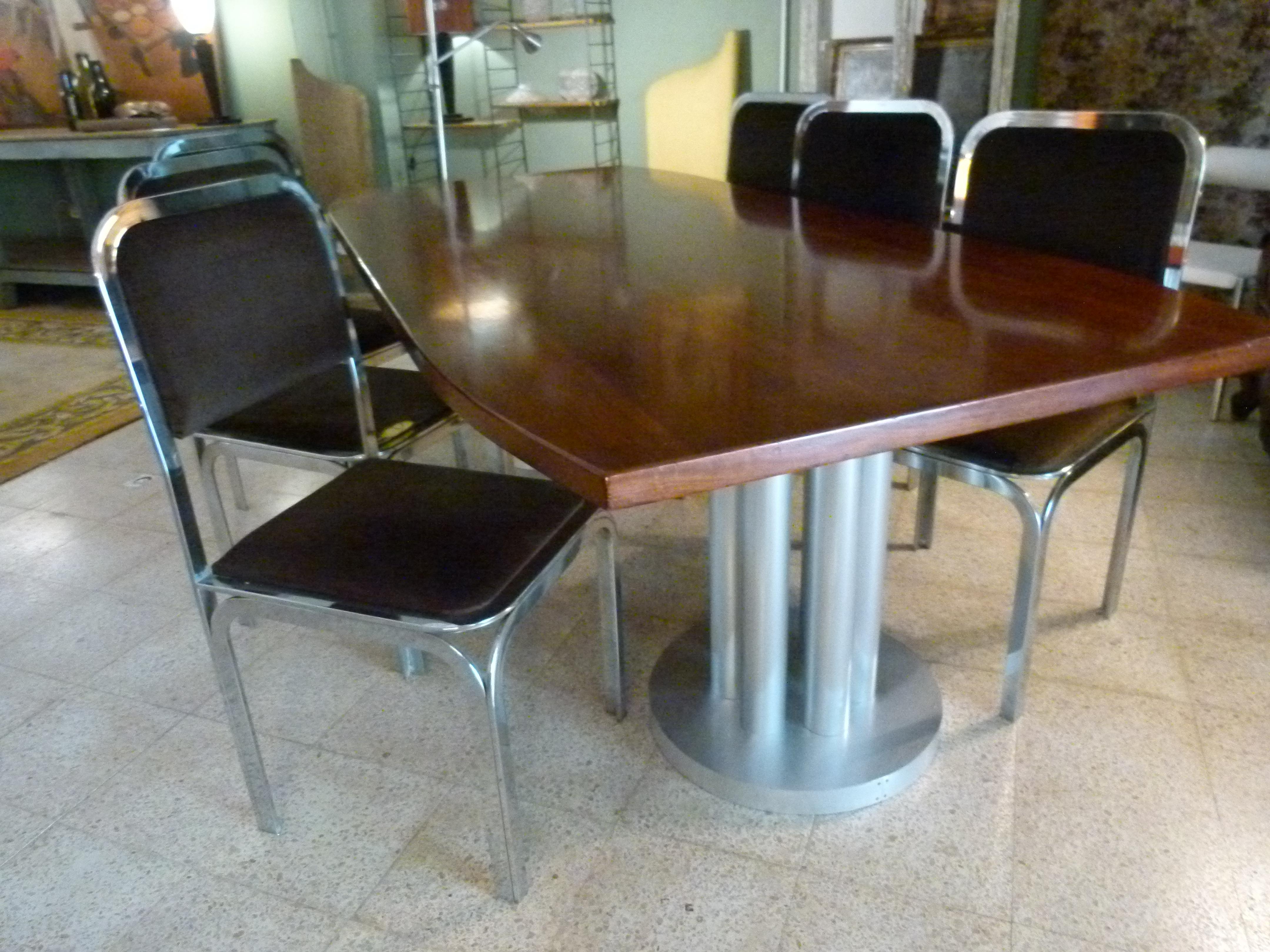 Large midcentury mahogany conference table. Rectangular top with aluminum cylindrical pedestals.




  