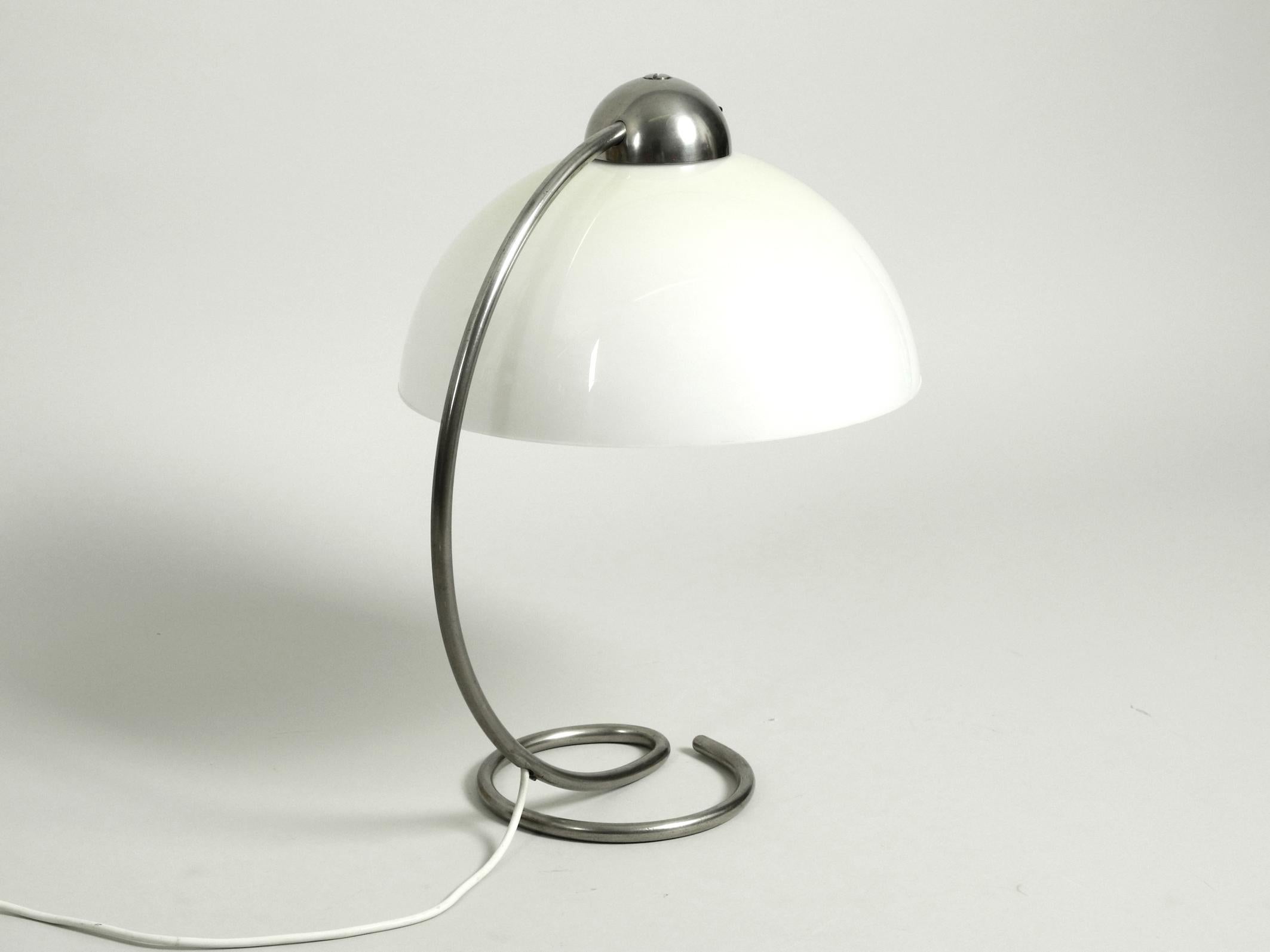 Large, very rare midcentury table lamp with plastic shade. Nickel-plated metal frame. Manufacturer is Schanzenbach & Co. Made in Germany
Made in the 1950s. Great Art Deco design in an unusual design.
One on-off rotary switch above the shade.
Very