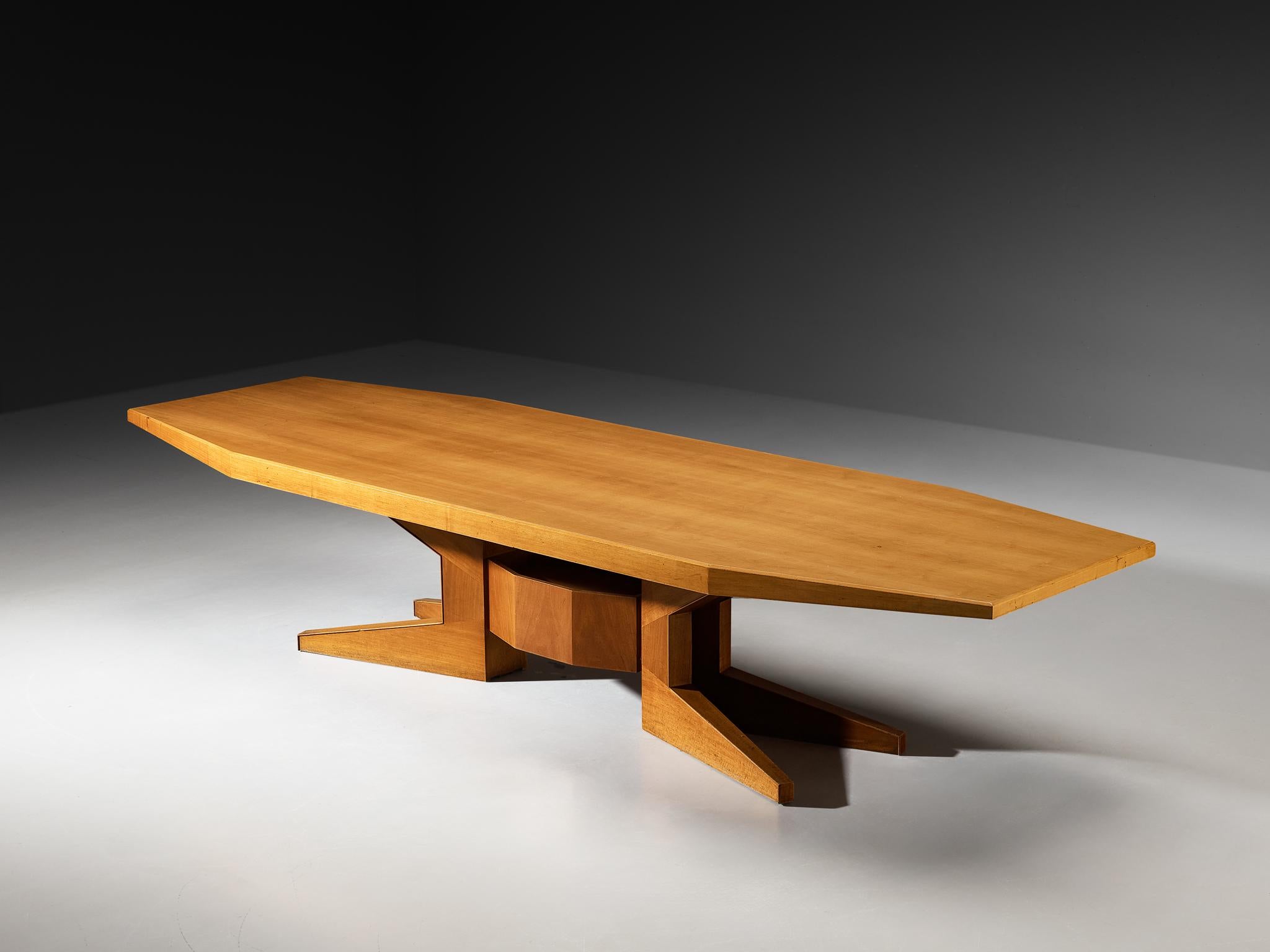 Dining or conference table, walnut, Italy, 1950s 

This table, crafted in the 1950s from walnut, presents a distinctively geometric form that speaks both to the craftsmanship of its time and to a certain forward-looking design sensibility. Measuring
