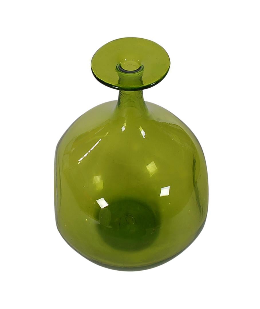 A beautiful sculptural form vase hand blown by Wayne Husted for Blenk Glass Co., circa 1960s. It consists of thick avocado colored clear glass with two dented sides. Very eye-catching piece.