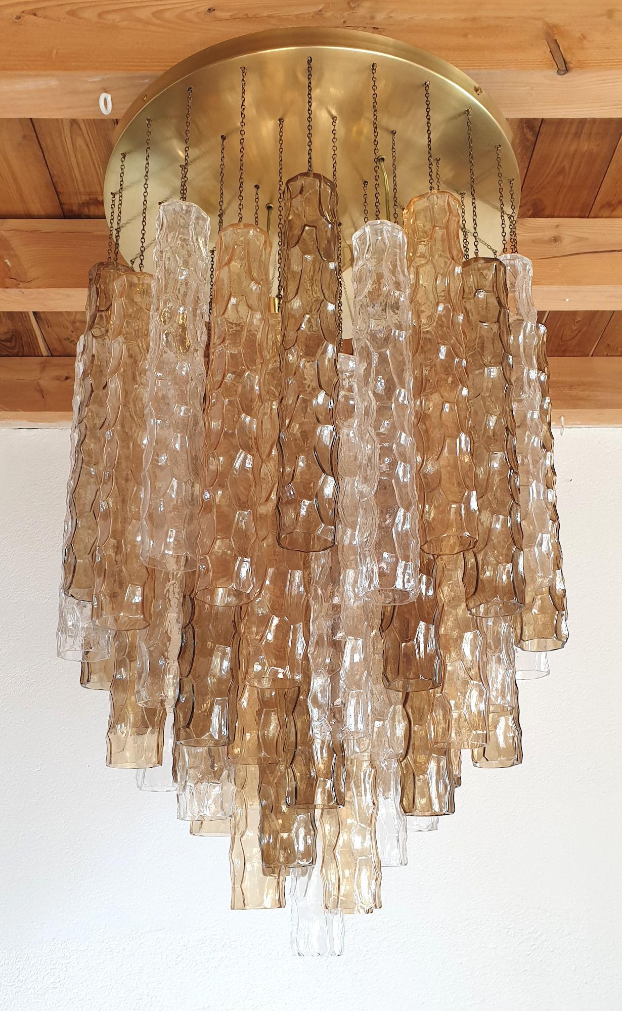 Large Mid-Century Modern Murano glass flush mount chandelier, by Mazzega, Italy, 1970s.
Made of alternating 3 colors of bamboo shaped Murano glasses: transparent, beige and brown.
Around 60 tubes of glass in excellent condition, for this 5 tiers