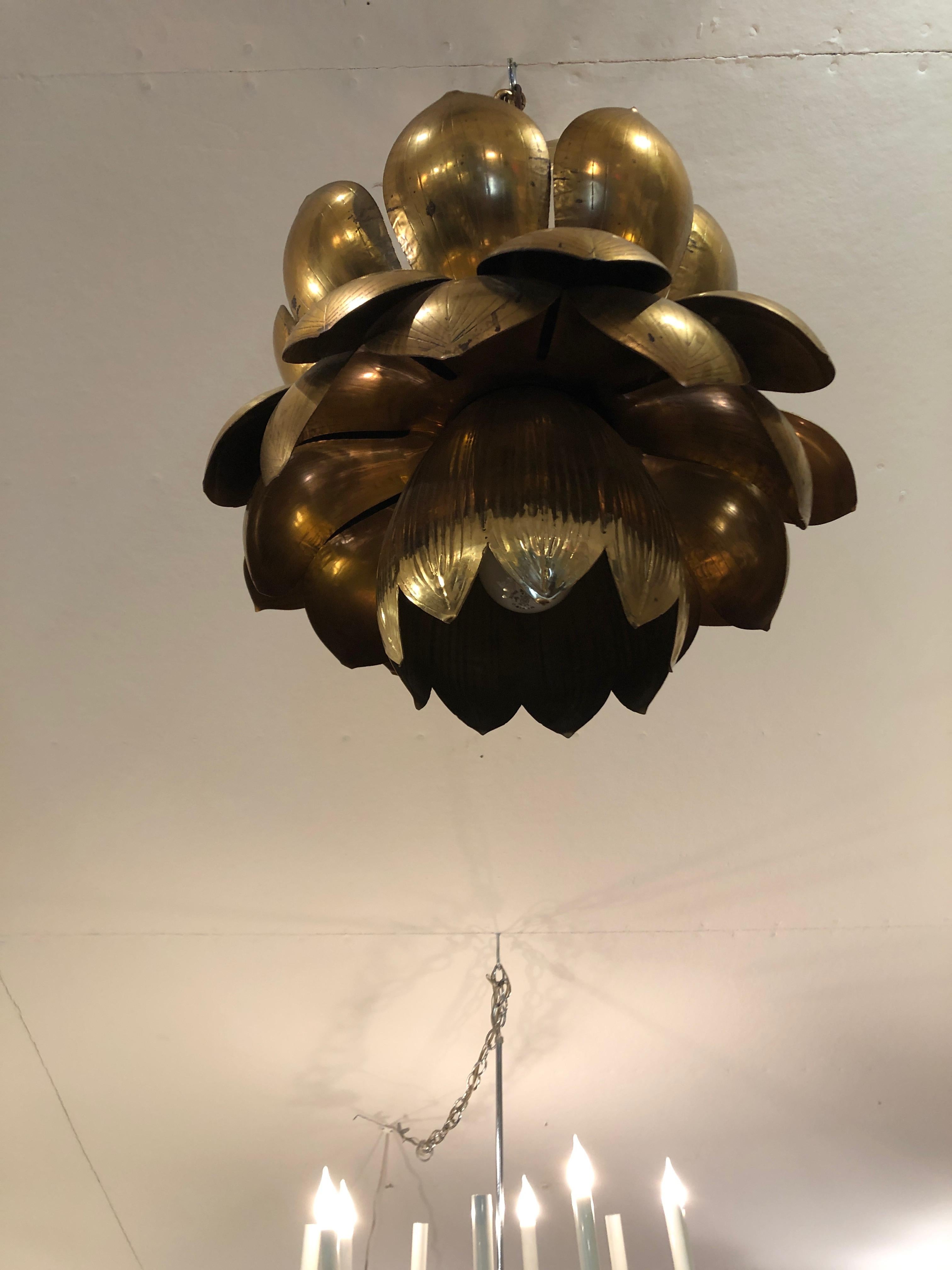 Iconic super chic 1970s Feldman large brass lotus pendant light.
Takes one standard bulb and three chandelier bulbs. Original brass canopy included.