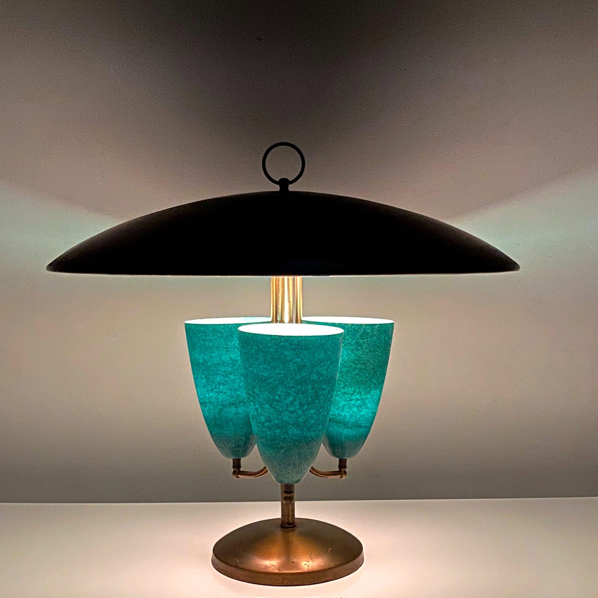 Large Modernist Brass Canopy Fiberglass Cone Table Lamp

Remarkable table lamp by Light House Lamp & Shade Co. of California c1950's.
Brass saucer shade with ring finial canopies a trio of jade green fiberglass cone uplighters, made by Marplex Co.