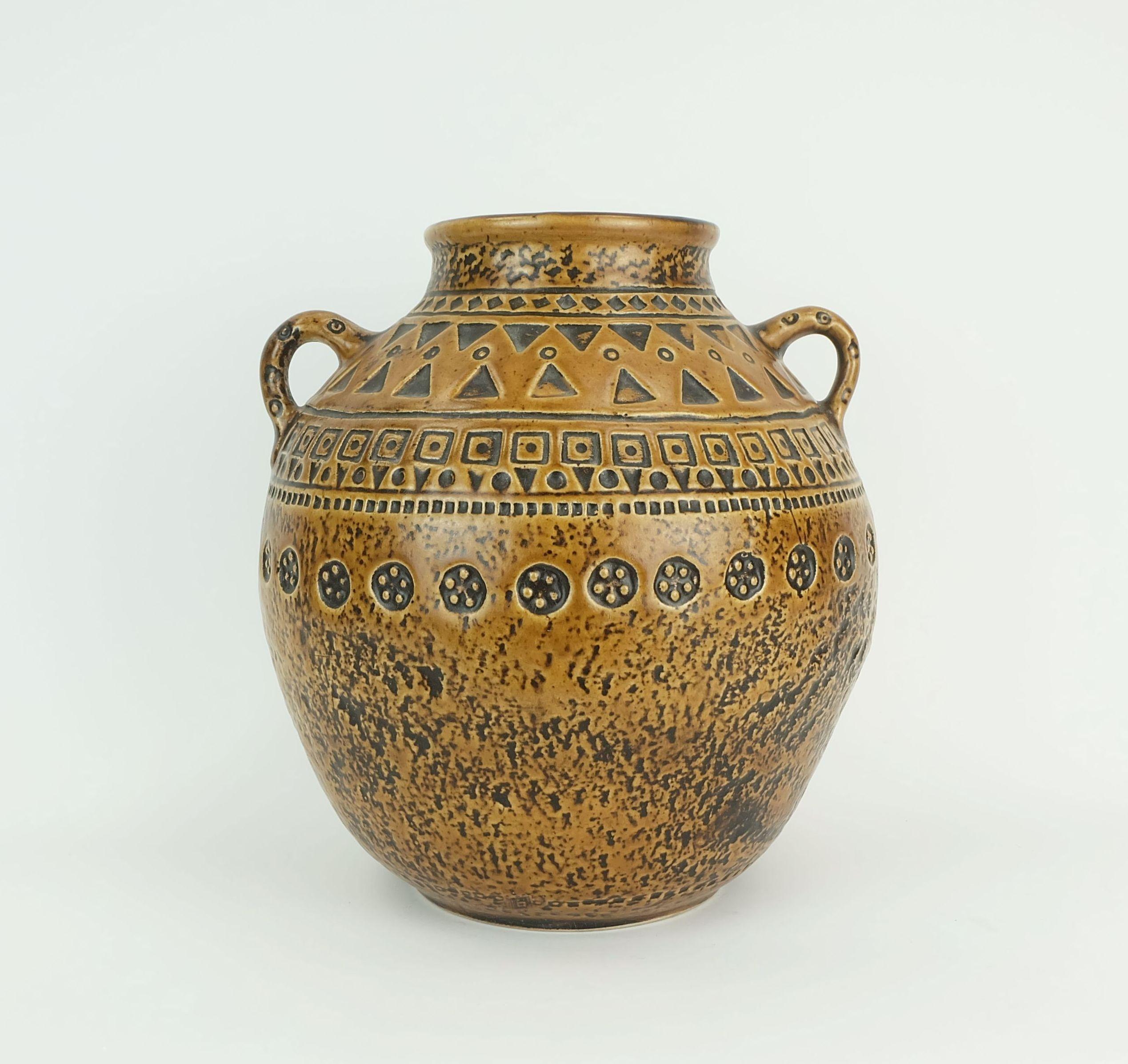 Very beautiful large mid century ceramic vase. Relief decor in ochre and dark brown. Unknown manufacturer. Not marked. The decor and style are reminiscent of Jasba vases.

Dimensions in cm:
Height 28 cm, diameter 26 cm.

Dimensions in inches:
Height