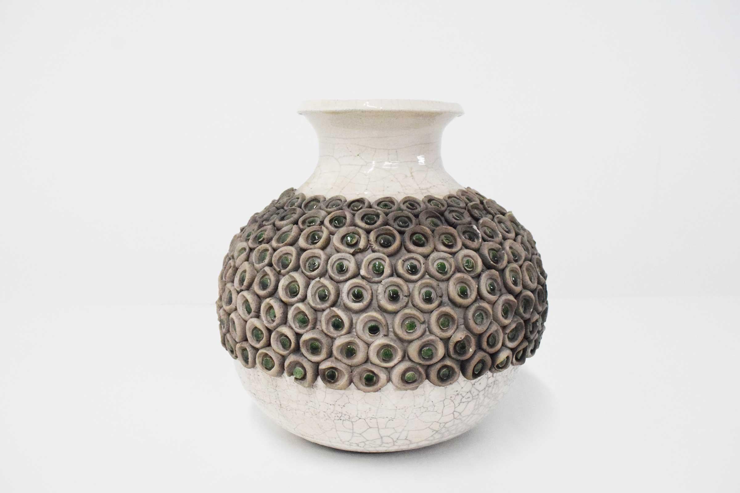 Lots of interesting detail in this beautiful Mid-Century Modern ceramic vase.  A glazed ceramic vase embellished circular ceramic circles adorned with green glazed ceramic dots. 
