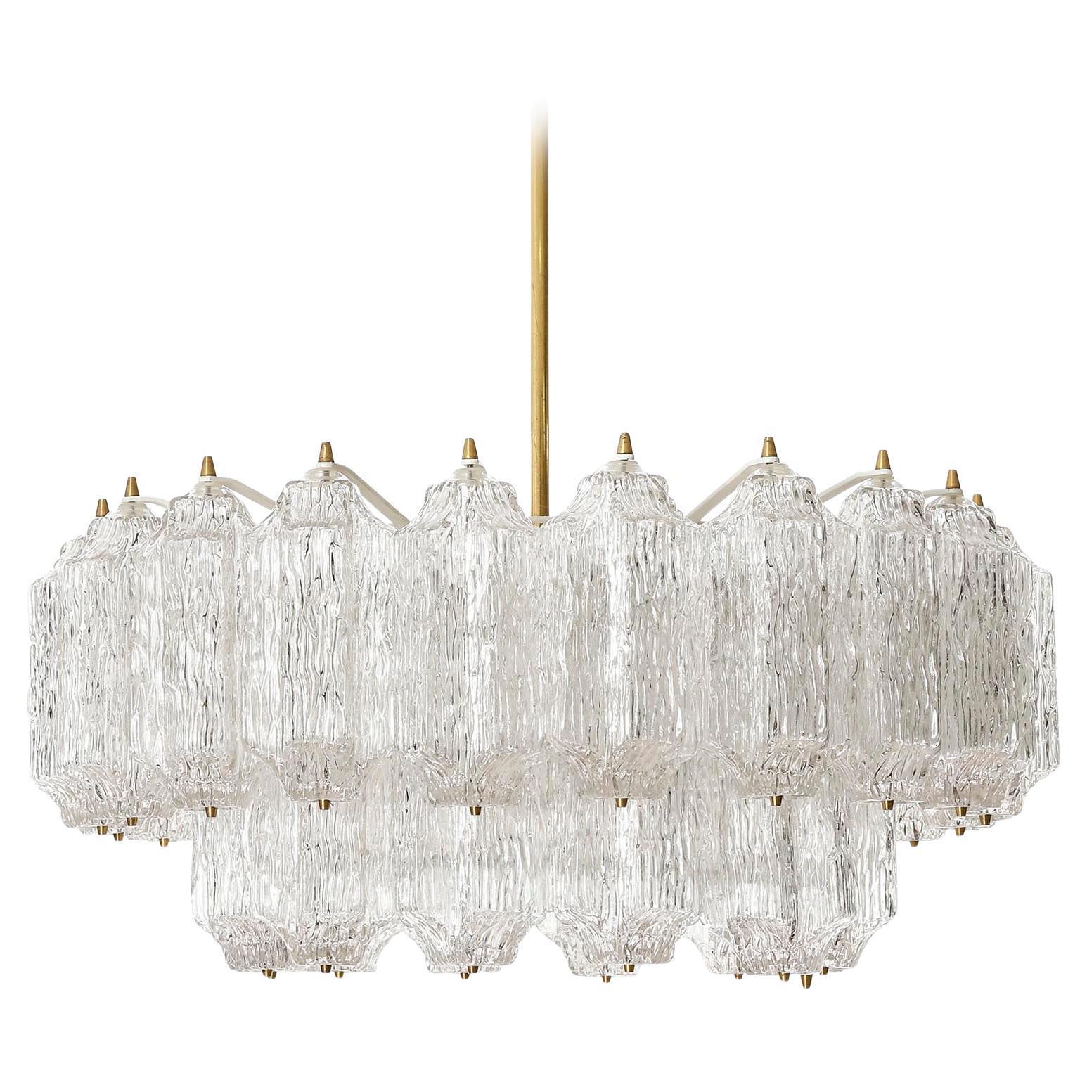 A large and fantastic light fixture by J.T. Kalmar, Vienna, Austria, manufactured in midcentury, circa 1970 (late 1960s or early 1970s).
The light consist of a white painted metal frame which holds textured glass pieces with brass bolts. The