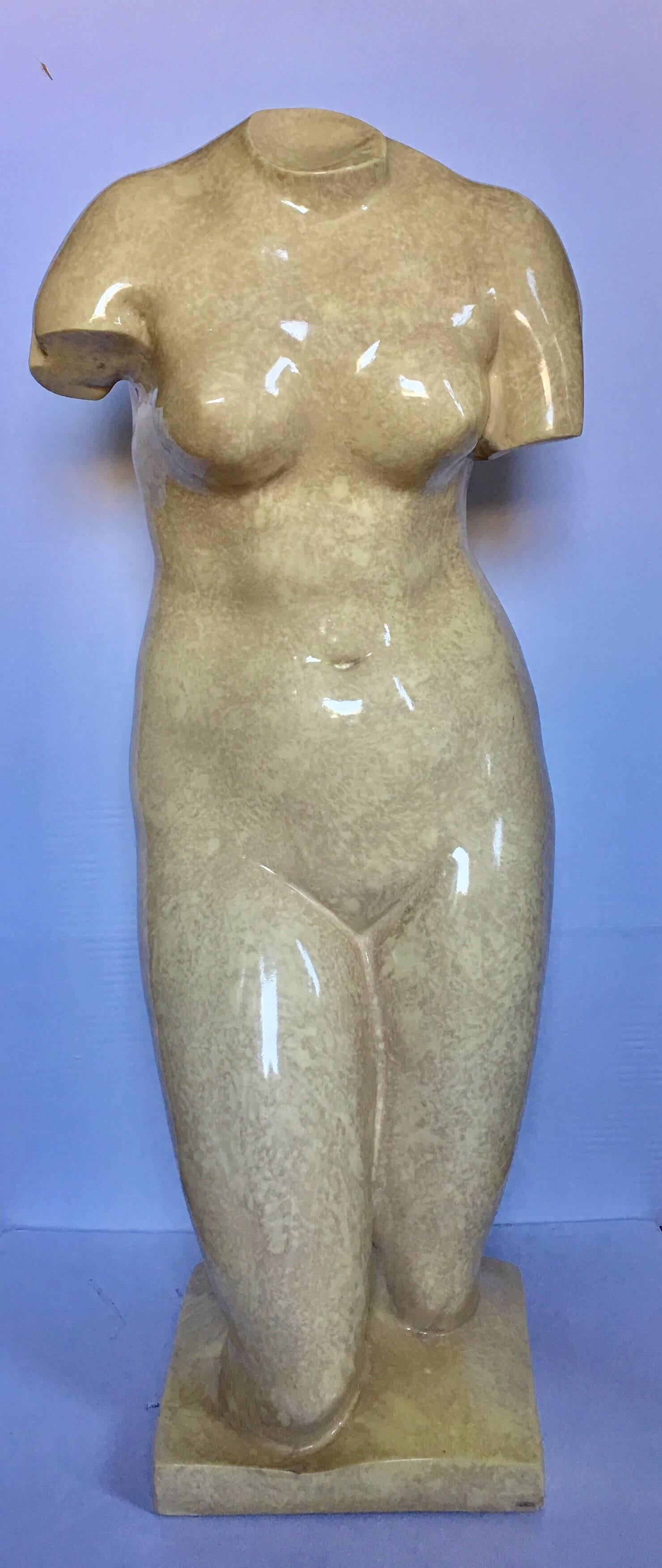 Dramatic scaled Mid-Century Modern classically inspired nude female torso bust floor statue. Plaster mold features a hand applied high gloss lacquered marble or stone like finish in neutral tan/beige tones.