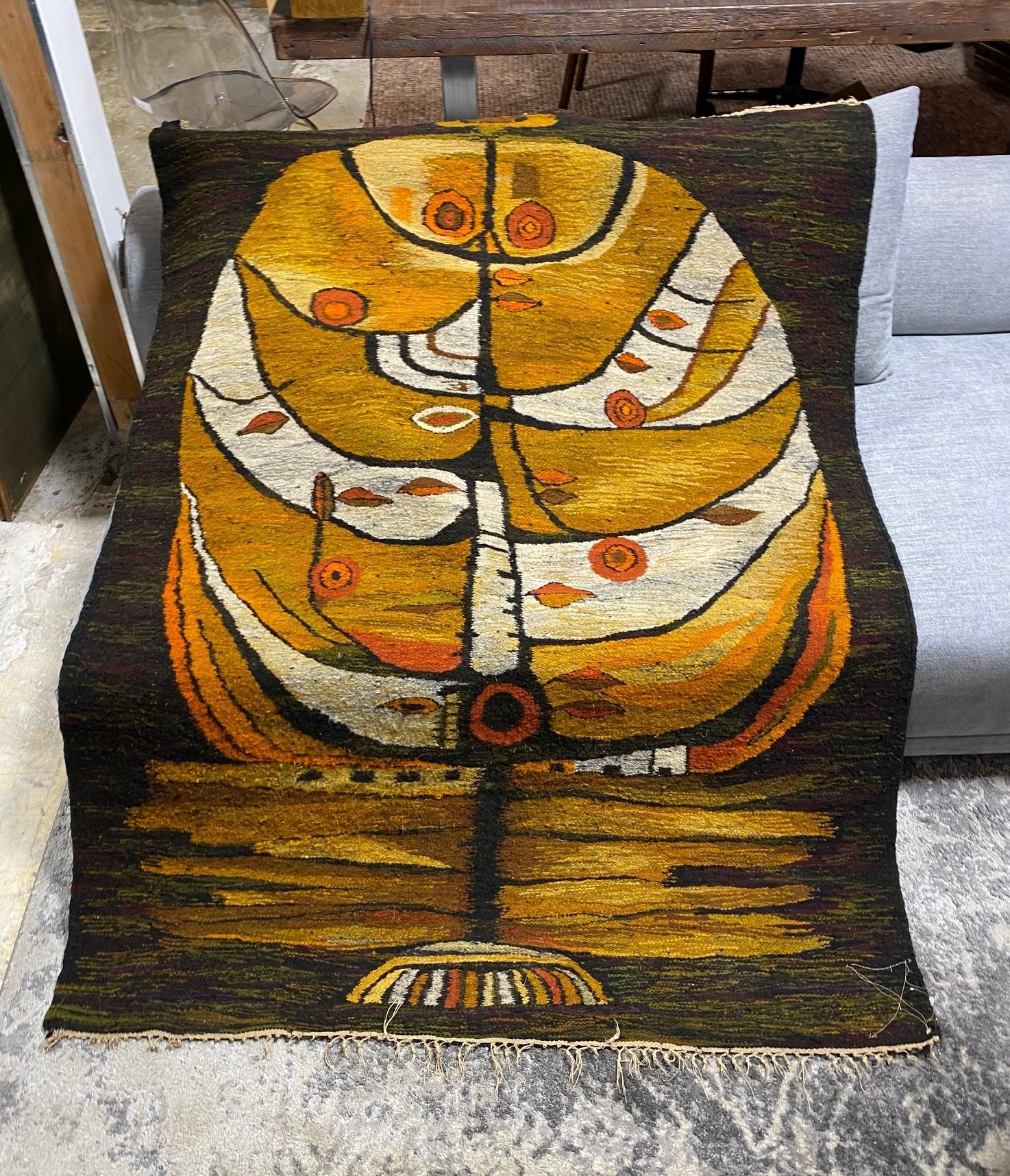 A truly wonderful and rivetting large Mid-Century Modern tapestry / wall hanging / rug with fantastic graphic design and rich warm colors. Handwoven from wool.

Retains the original polish maker cepelia tag with the designer and weaver information