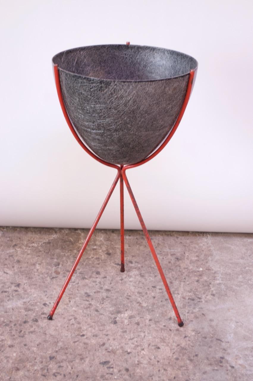 Planter by Kimball composed of a gray spun fiberglass vessel supported by a painted iron tripod base, circa 1950s. The paint is vintage, although unlikely original, and shows moderate patina / paint loss. The fiberglass is in good, vintage shape