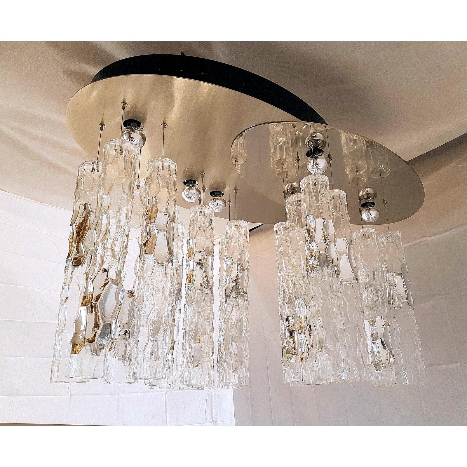 Oval shape, large Mid-Century Modern flush mount chandelier, with Murano bamboo glass pendants, by AV Mazzega, 1970s.
The ceiling plate is made of mirrored chrome, and brushed steel, composing a unique oval shape.
The vintage chandelier has Murano