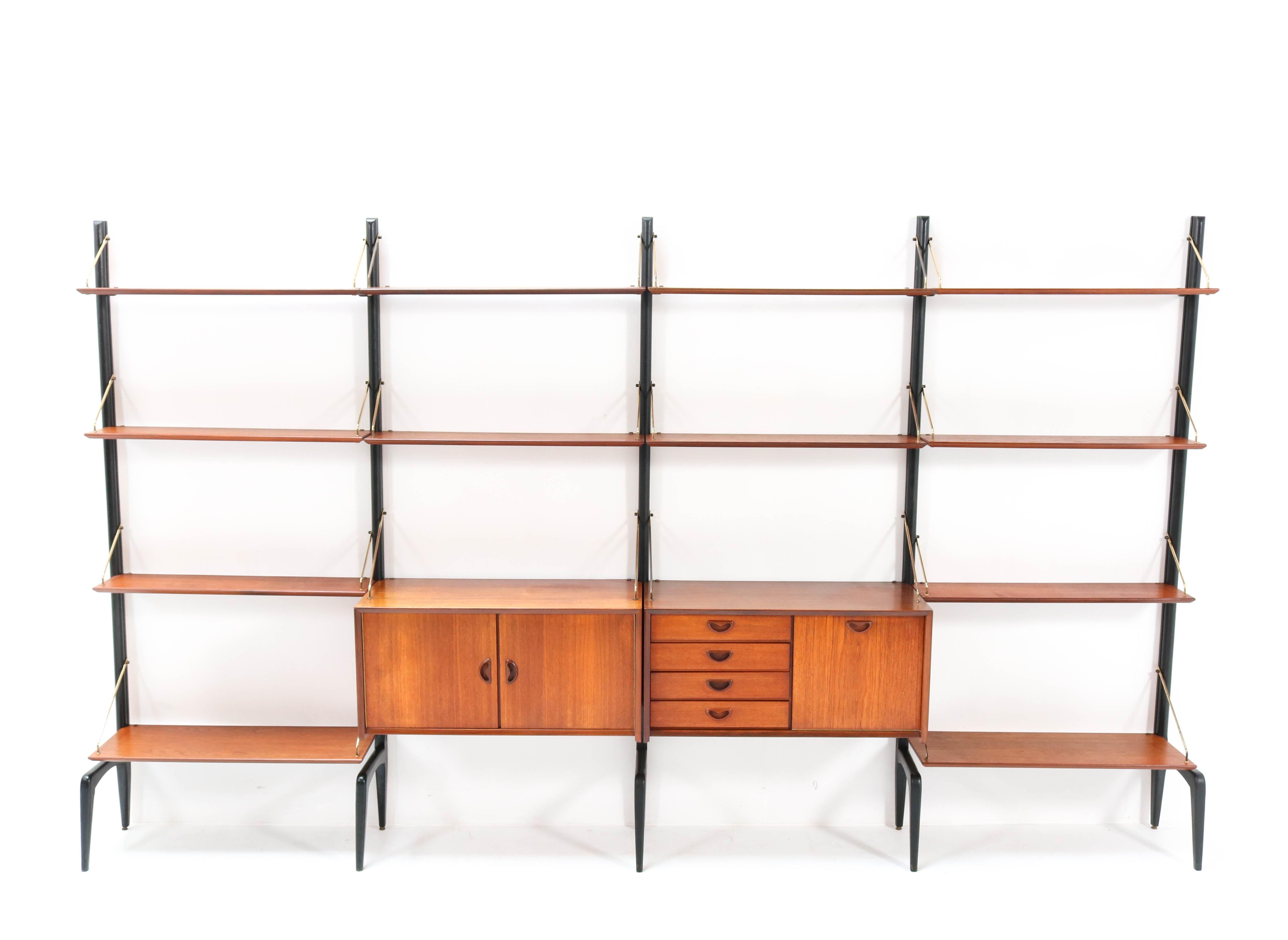 Magnificent and extra large Mid-Century Modern free standing modular wall unit.
Design by Louis van Teeffelen for Webe.
Striking Dutch design from the 1950s.
This wall unit consists of:
5 original black lacquered wooden uprights H: 200 cm or