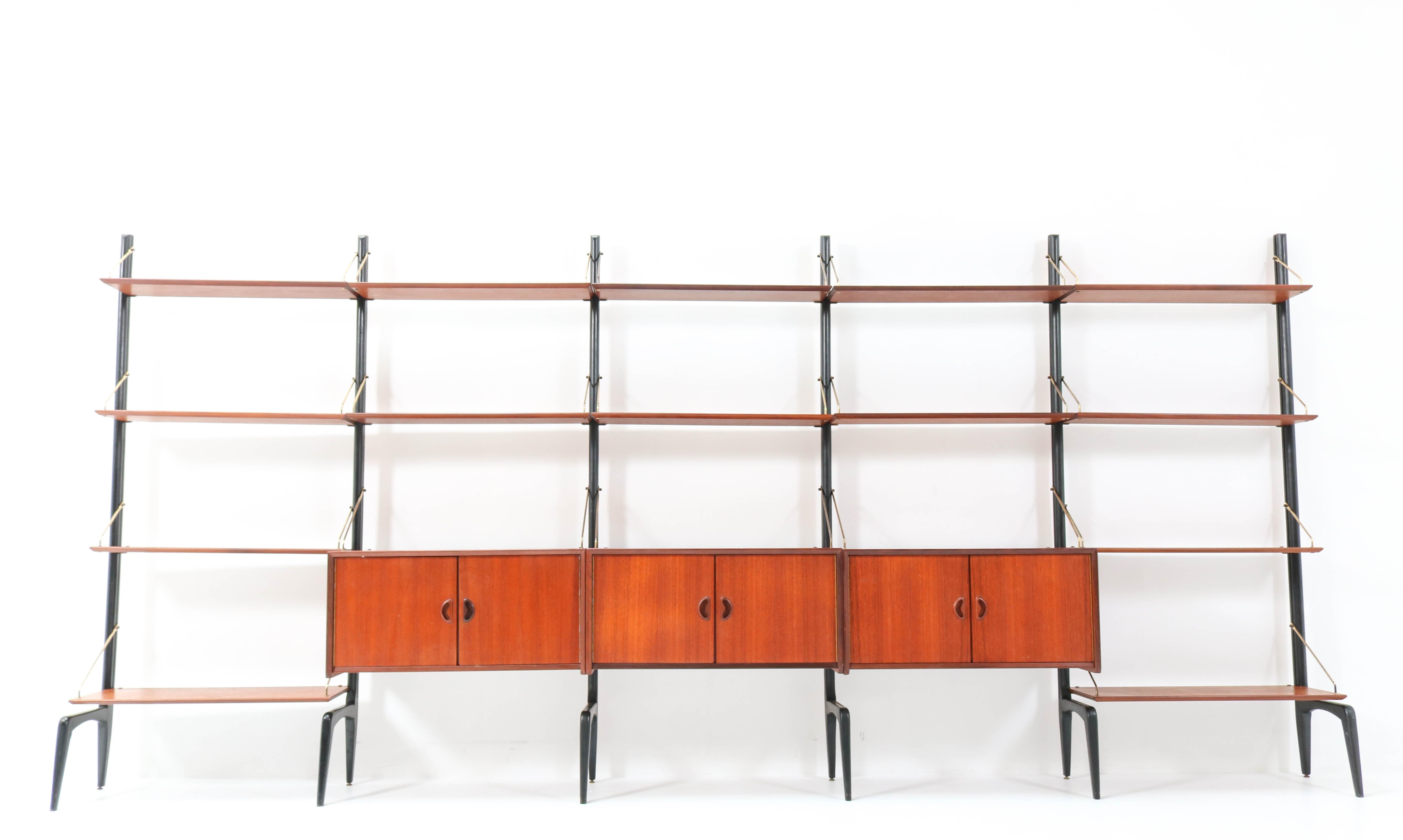 Magnificent and extra large Mid-Century Modern free standing modular wall unit.
Design by Louis Van Teeffelen for WéBé.
Striking Dutch design from the 1950s.
This wall unit consists of:
6 original black lacquered wooden uprights H: 200 cm or