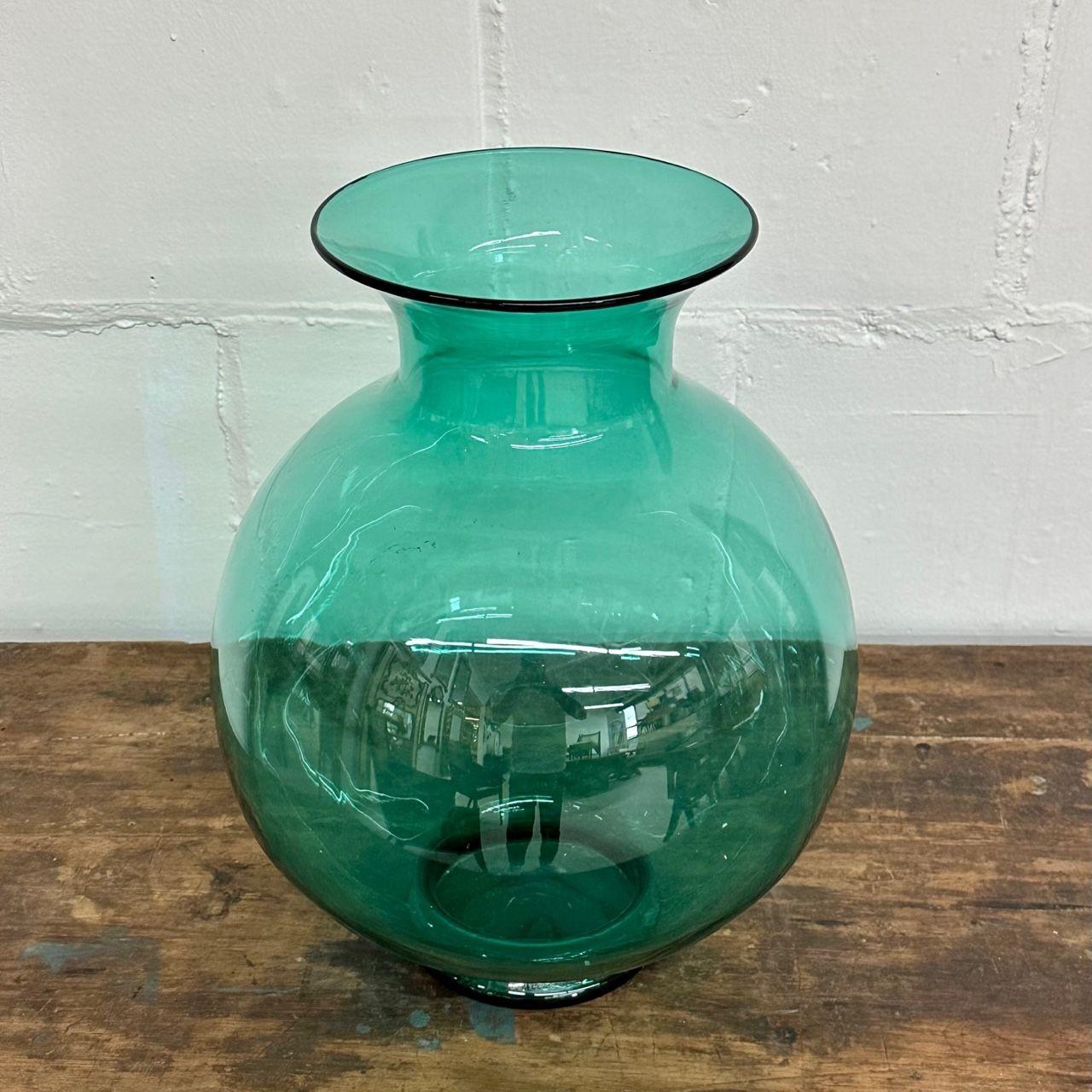 Large Mid-Century Modern hand blown Glass Turquoise Table Vase / Vessel by Blenko
 
Spherical teal hand blown glass flower vase or centerpiece by Blenko Glassworks.
 
Hand Blown Glass
United States, circa 1960s
 
Opening is 7.5