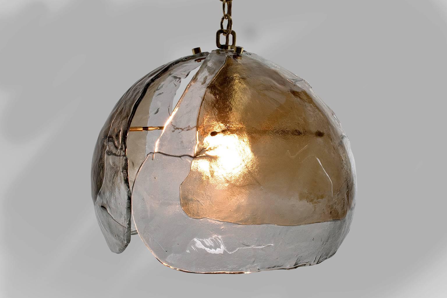 Large mid-Century Modern pendant light by Kaiser Leuchten, Germany. This is the largest model manufactured and consists of three very heavy, handblown, petals in clear and smoked glass with brass hardware. In excellent condition.

Label present of