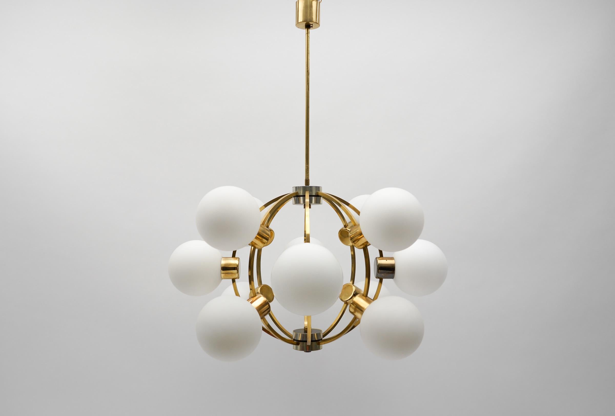 Large Mid-Century Modern Orbit or Sputnik Lamp with 12 Opaline Glass Balls

Diameter: 25.19 in (64 cm)
Height: 33.07 in (83 cm)

Executed in glass, metal and brass. The lamp needs 10 x E27 / E26 Edison screw fit bulb, is wired, in working condition