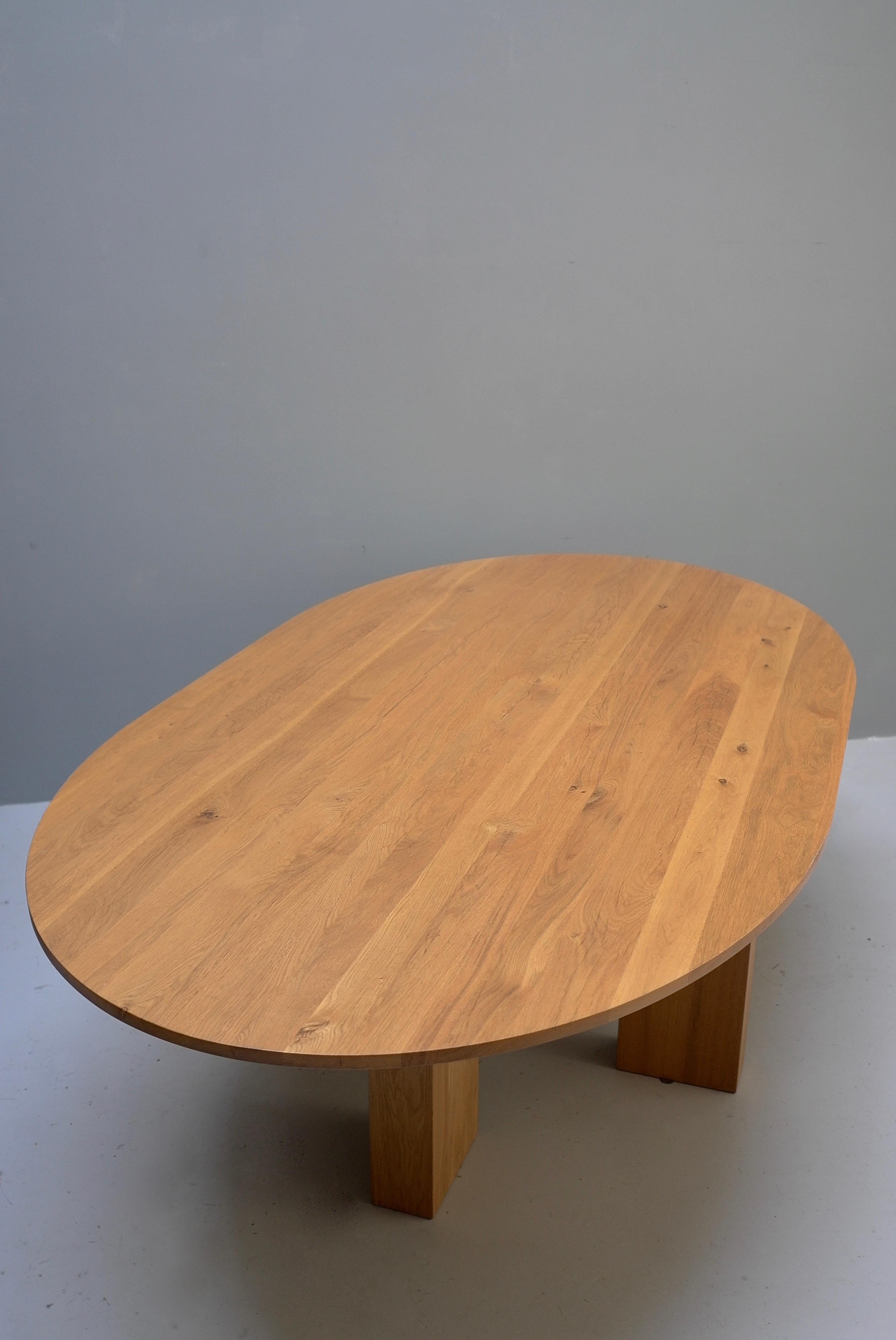 Large Mid-Century Modern Oval Oak European Dining table 

Would look great for example with Mario Bellini Cab Chairs.