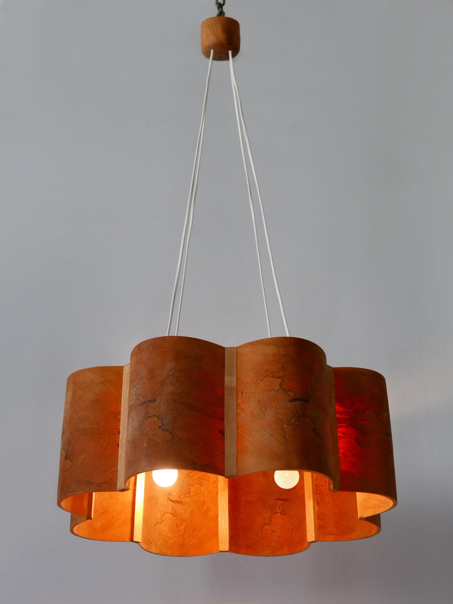 Extremely rare, elegant and highly decorative Mid-Century Modern four-flamed pine wood pendant light or chandelier. Designed and manufactured in Sweden, 1960s. Marked on the top.

Executed in pine wood, the pendant lamp needs 4 x E27 / E26 Edison