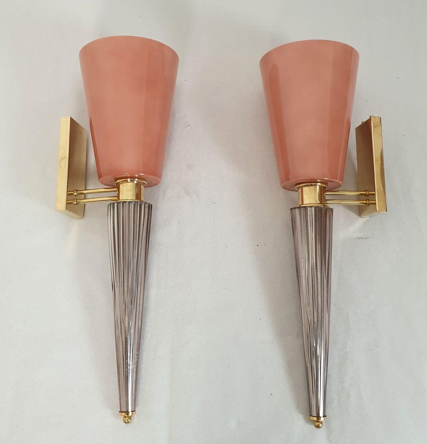 Pair of very tall Murano glass wall sconces, Attributed to Venini, Italy 1970s.
The Mid-Century Modern sconces are made of a top salmon pink Murano glass vase nesting the light bulb.
The glass is double layered: the inside is white. It's