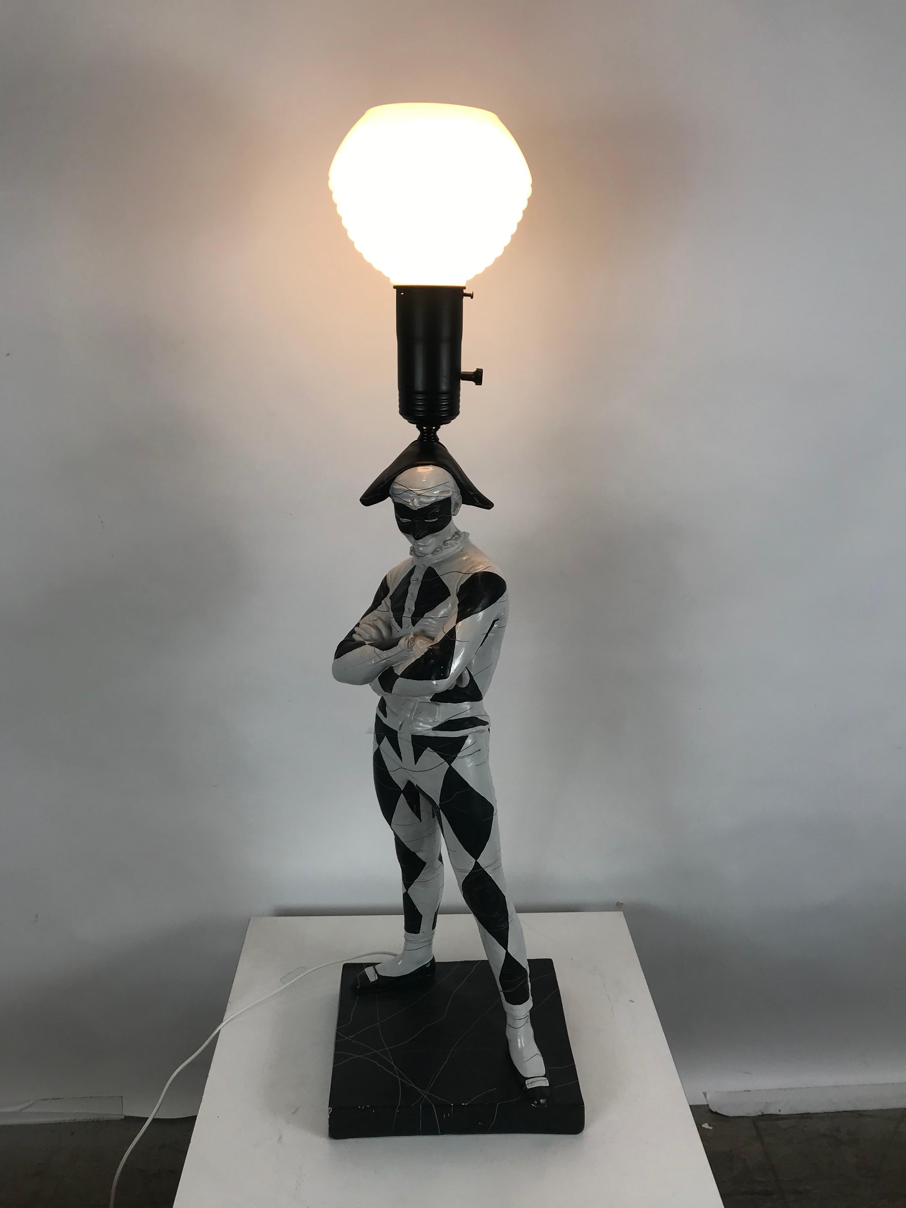 Large Mid-Century Modern plaster lamp, court jester by G. W, Hamilton. Hand painted plaster harelequin modeled after a famous life-size marble sculpture by Rene de Saint Marceaux located in France. Retains original lamp shade, fits seamlessly into
