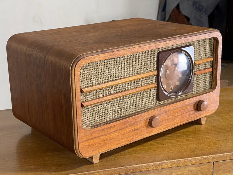 Striking and wonderfully designed large table-top Mid Century radio by General Electric. It is working and has a plug in the back. At some time it was converted from tubes to a battery pack. Picks up AM stations. Slight lifting of veneer in the