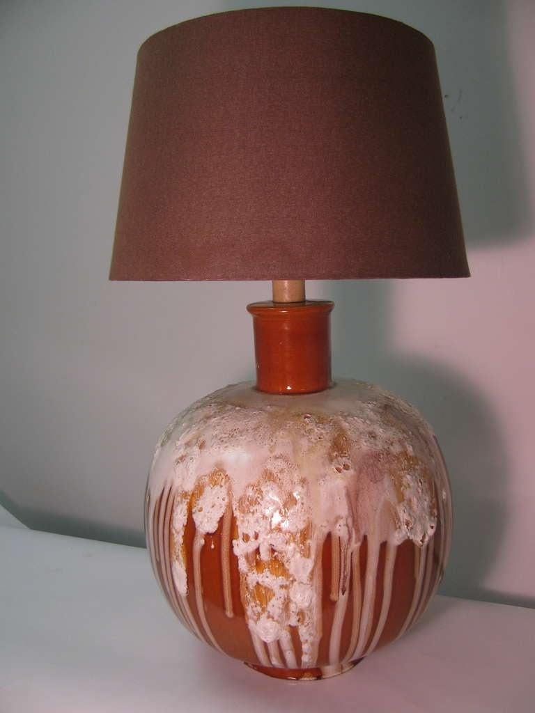 Very large midcentury pottery lamp with a drip glaze. Lamp with combination of glaze and size, has a commanding presence. New wiring. 24 in. To top of socket.