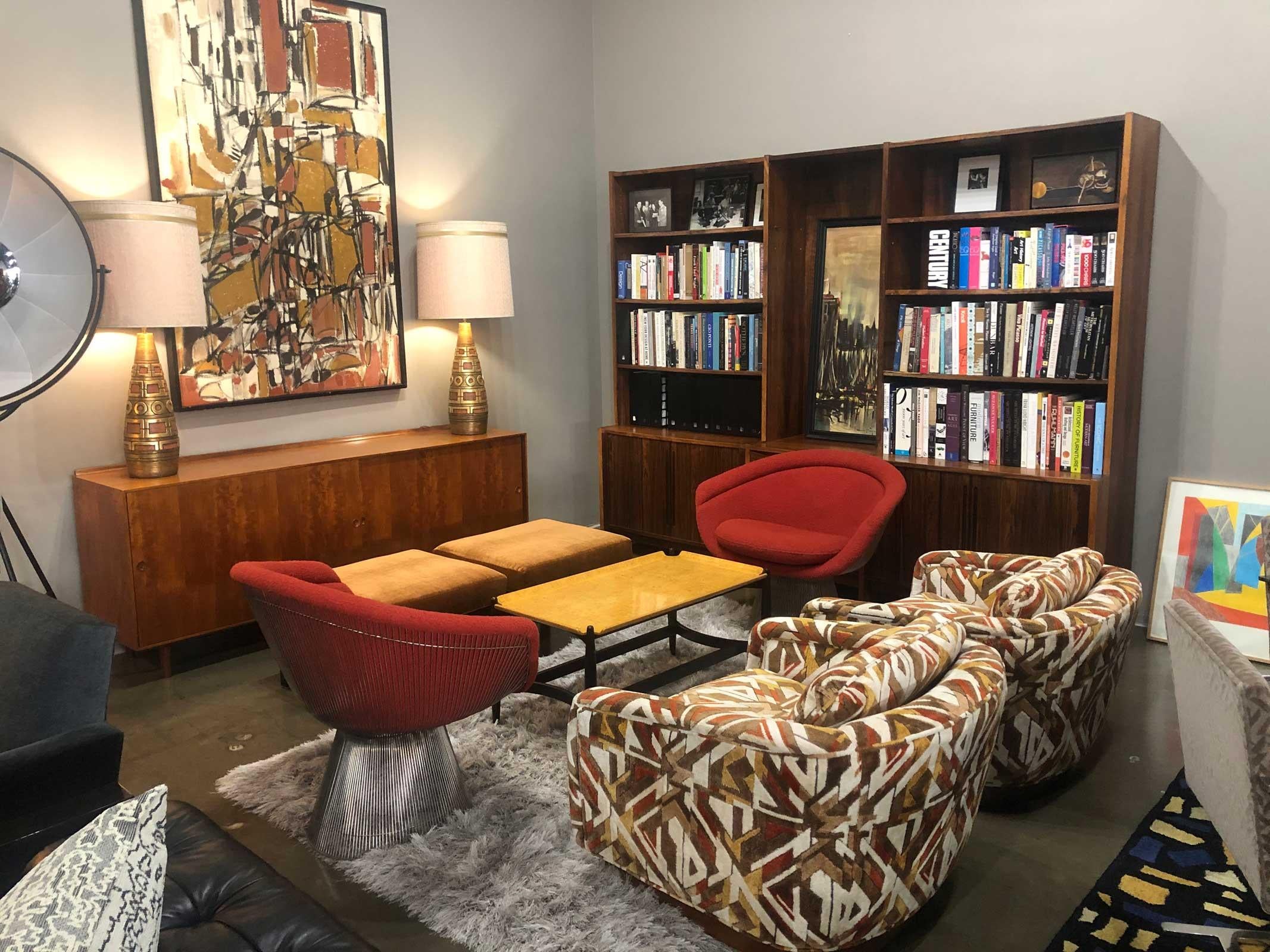 Beautiful rosewood bookcase and storage cabinets. Base features two tambour door storage compartments which bank a middle section of five drawers. The upper sections has four rows for books or other storage. The middle section is open but has tabs