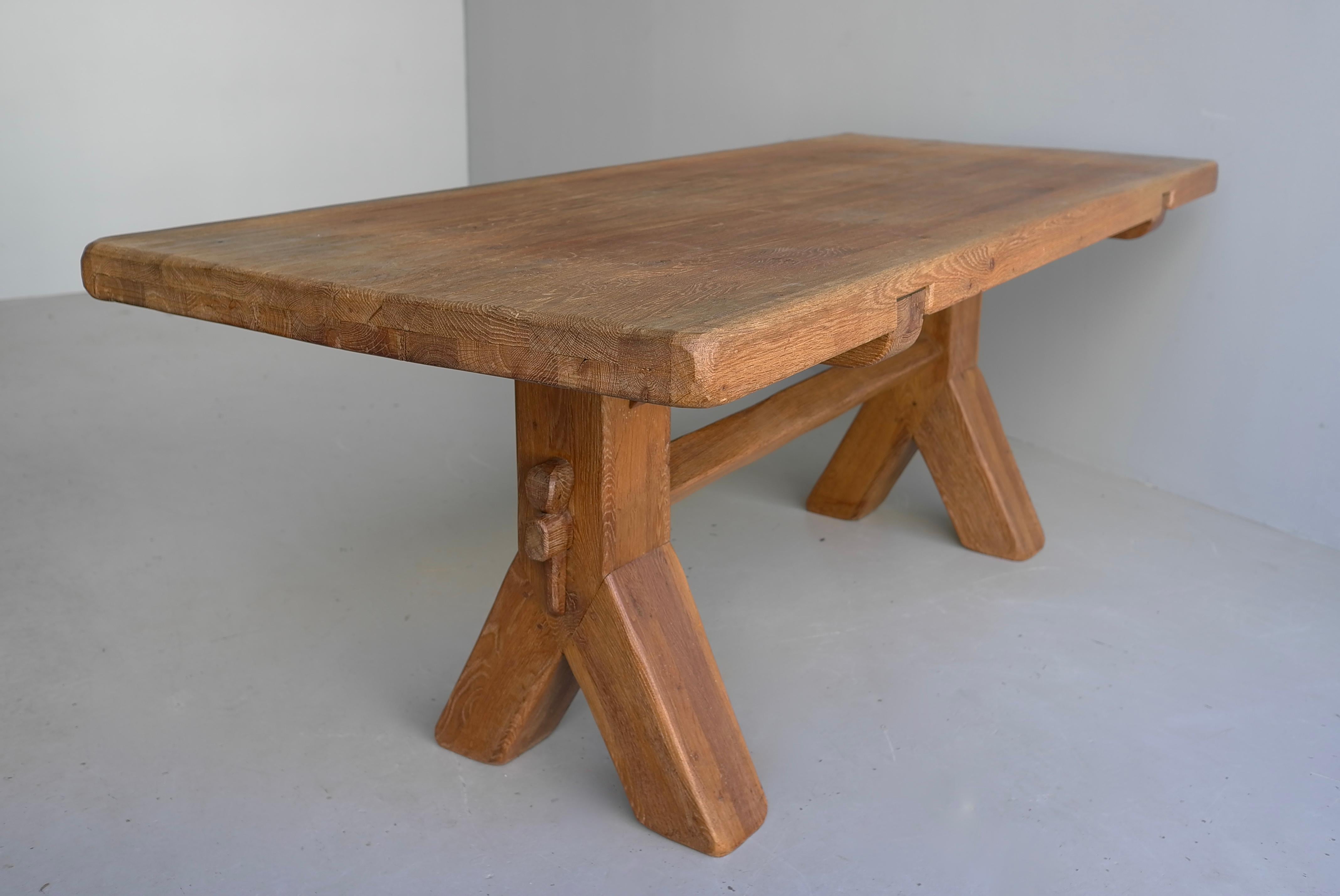 Large Mid-Century Modern Oak Dining table by De Puydt Belgium 1960's
Brutalist construction made of solid oak wood with two braced legs and a rectangular table top. De Puydt showcases traditional construction details such as pegged joints, chocked