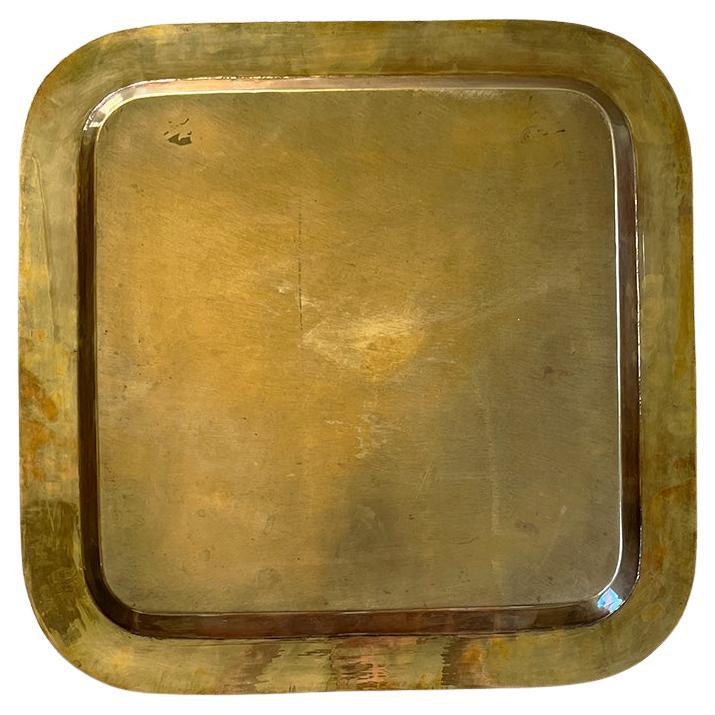 A stunning large mid-century modern solid brass serving tray. This Italian piece is square, with rounded edges. It is created from solid brass and is hand etched with a wheat motif and signed by the artist. This piece was sourced from the estate of