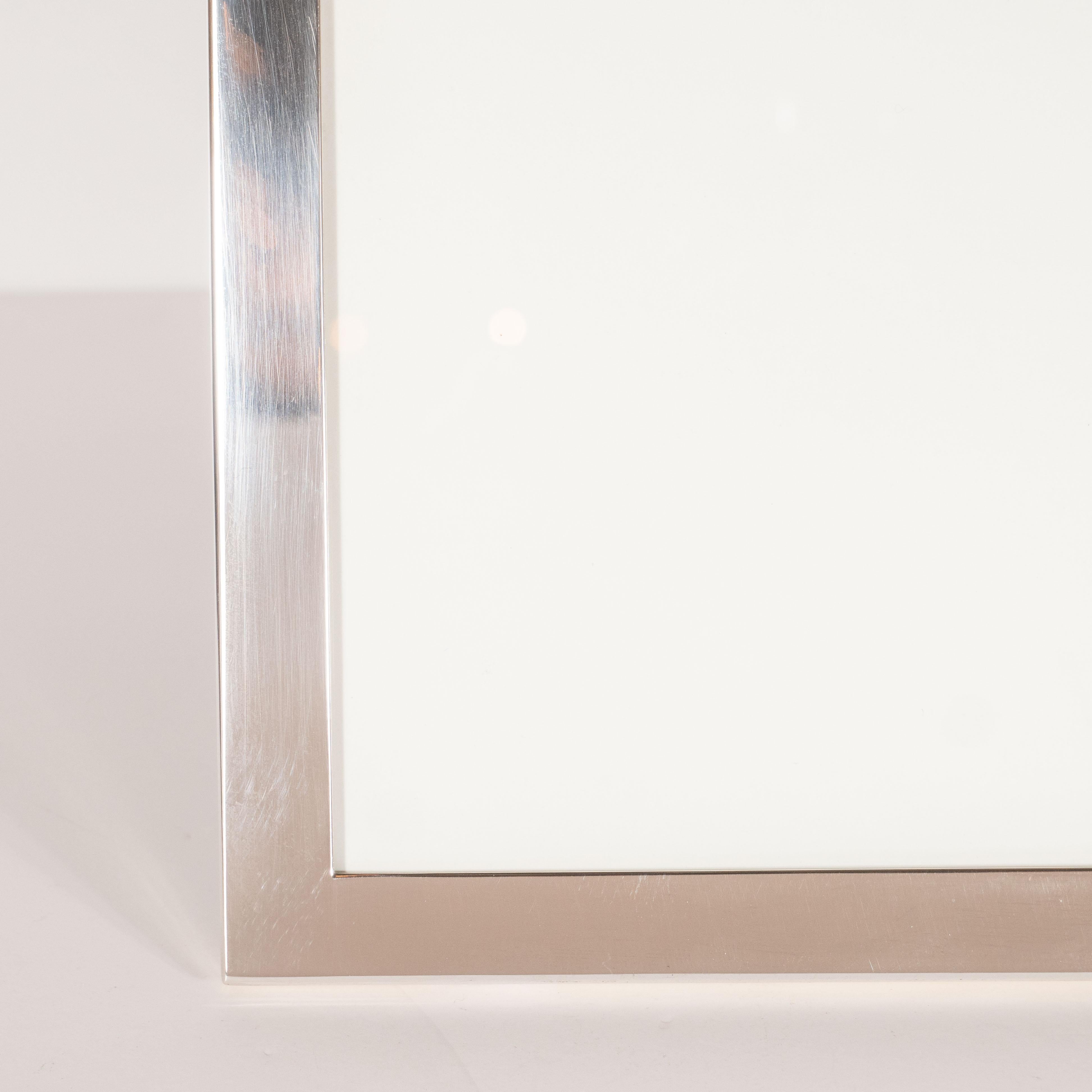 This refined picture frame was made by Tiffany & Co.- one of America's most storied luxury design firms, specializing in sterling silver, since 1837. It features an austere rectangular frame in lustrous polished sterling silver. With its