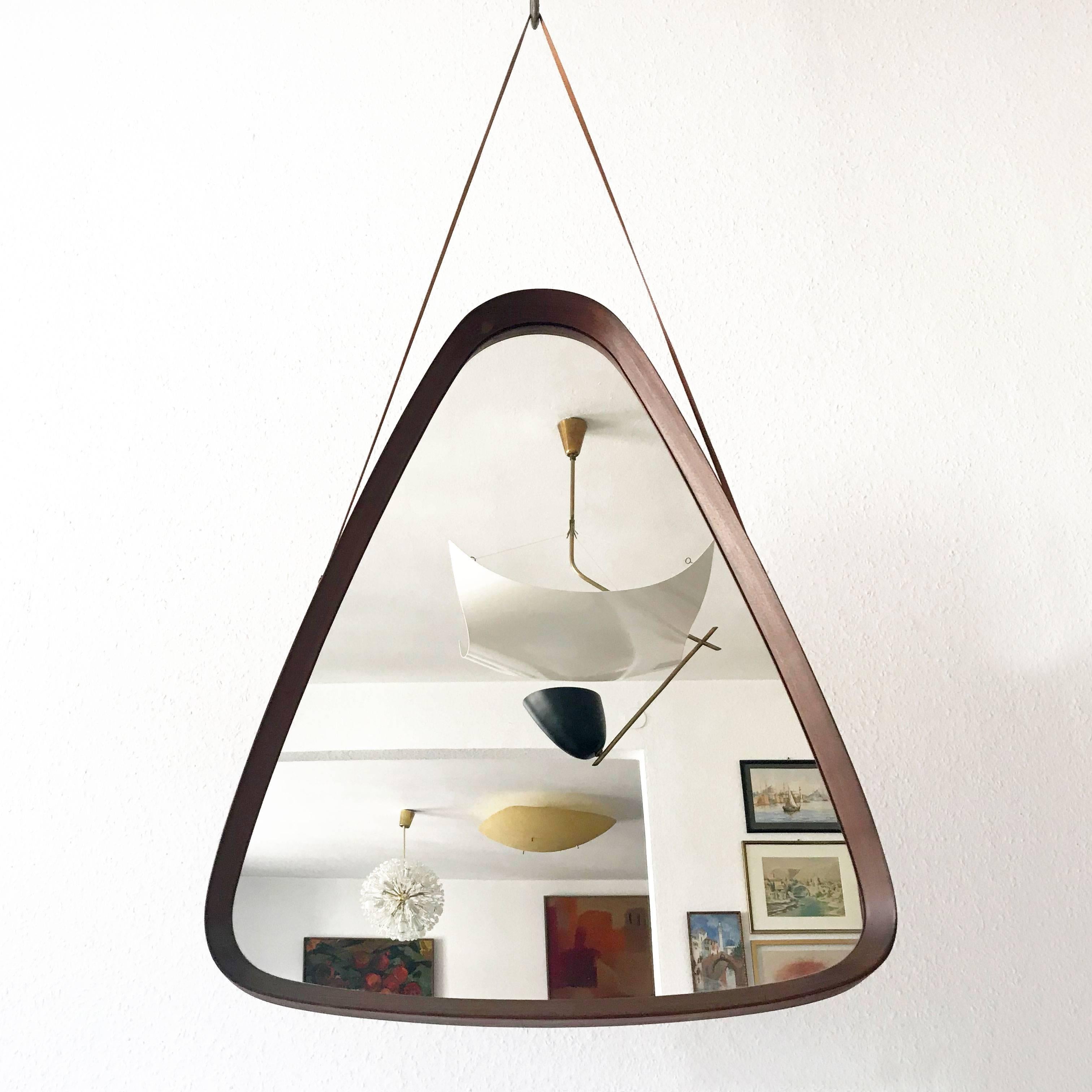 Decorative and extremely rare wall mirror in a rare triangle shape. With teak frame and fine details. Designed and manufactured probably in Denmark, 1960s.