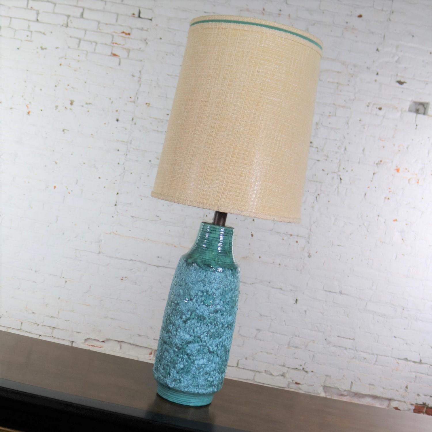 Handsome very large Mid-Century Modern ceramic table lamp with a gorgeous turquoise lava glaze and its original shade done in the style of the famed Fantoni. This great lamp is in wonderful vintage condition as is the large drum shade. Please see