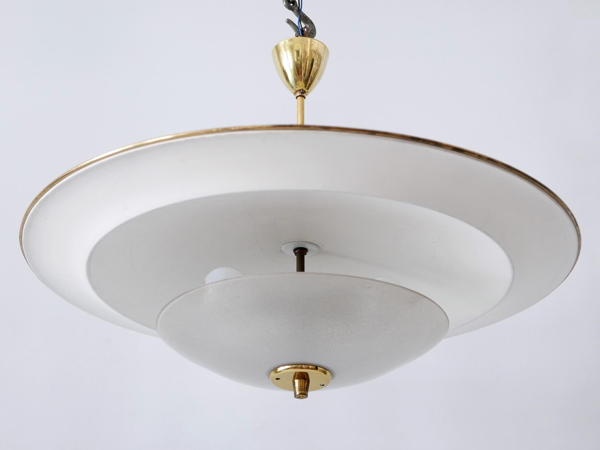 Large, rare and highly decorative Mid-Century Modern 'Ufo' ceiling light or pendant lamp. Designed & manufactured in Germany, 1950s.

Executed in aluminum sheet, textured glass and brass, the pendant lamp needs 3 x E27 / E26 Edison screw fit bulbs.
