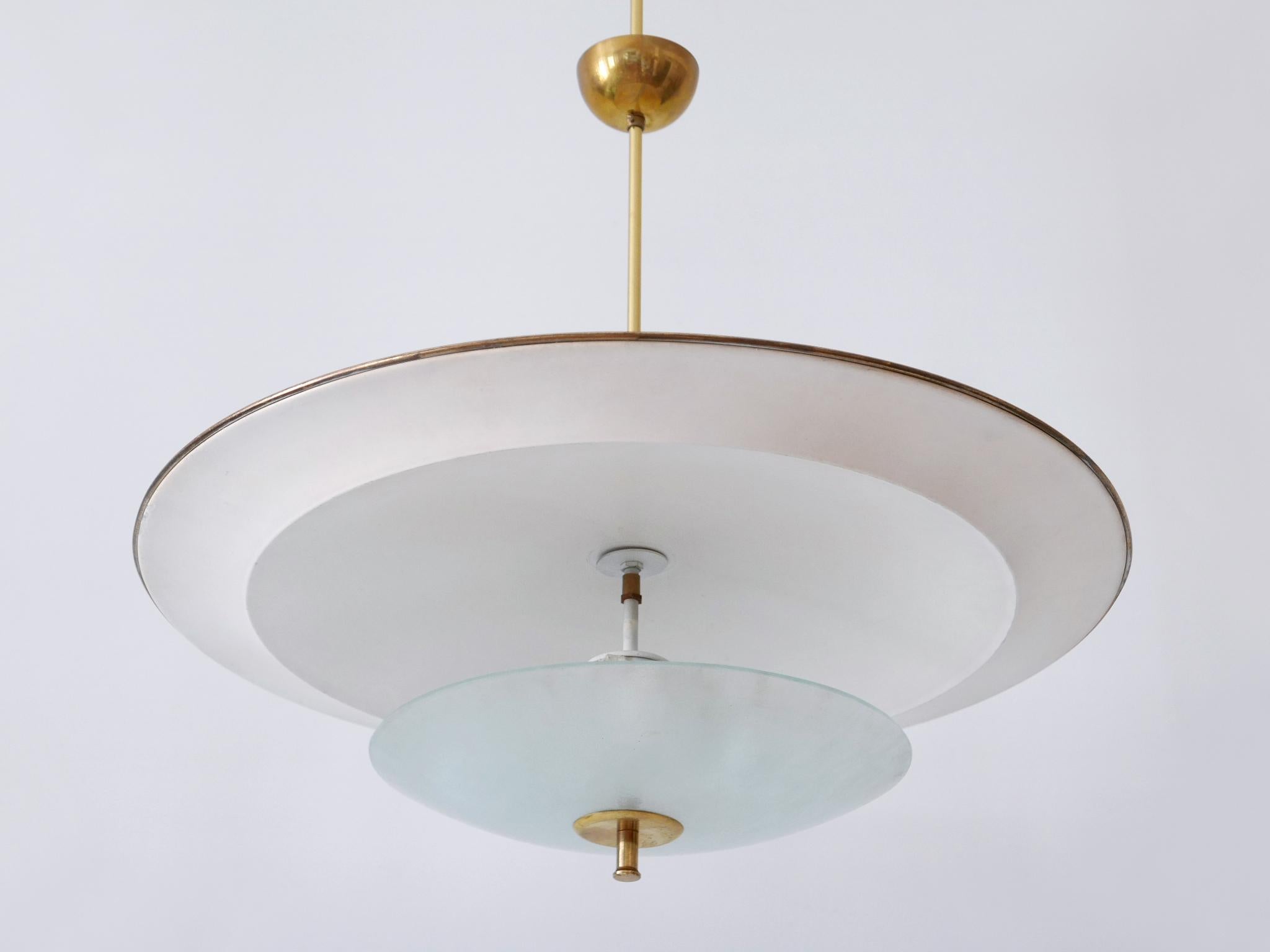 Large, rare and highly decorative Mid-Century Modern 'Ufo' ceiling light or pendant lamp. Designed & manufactured in Germany, 1950s.

Executed in aluminum sheet, textured glass and brass, the pendant lamp needs 2 x E27 / E26 Edison screw fit bulbs.