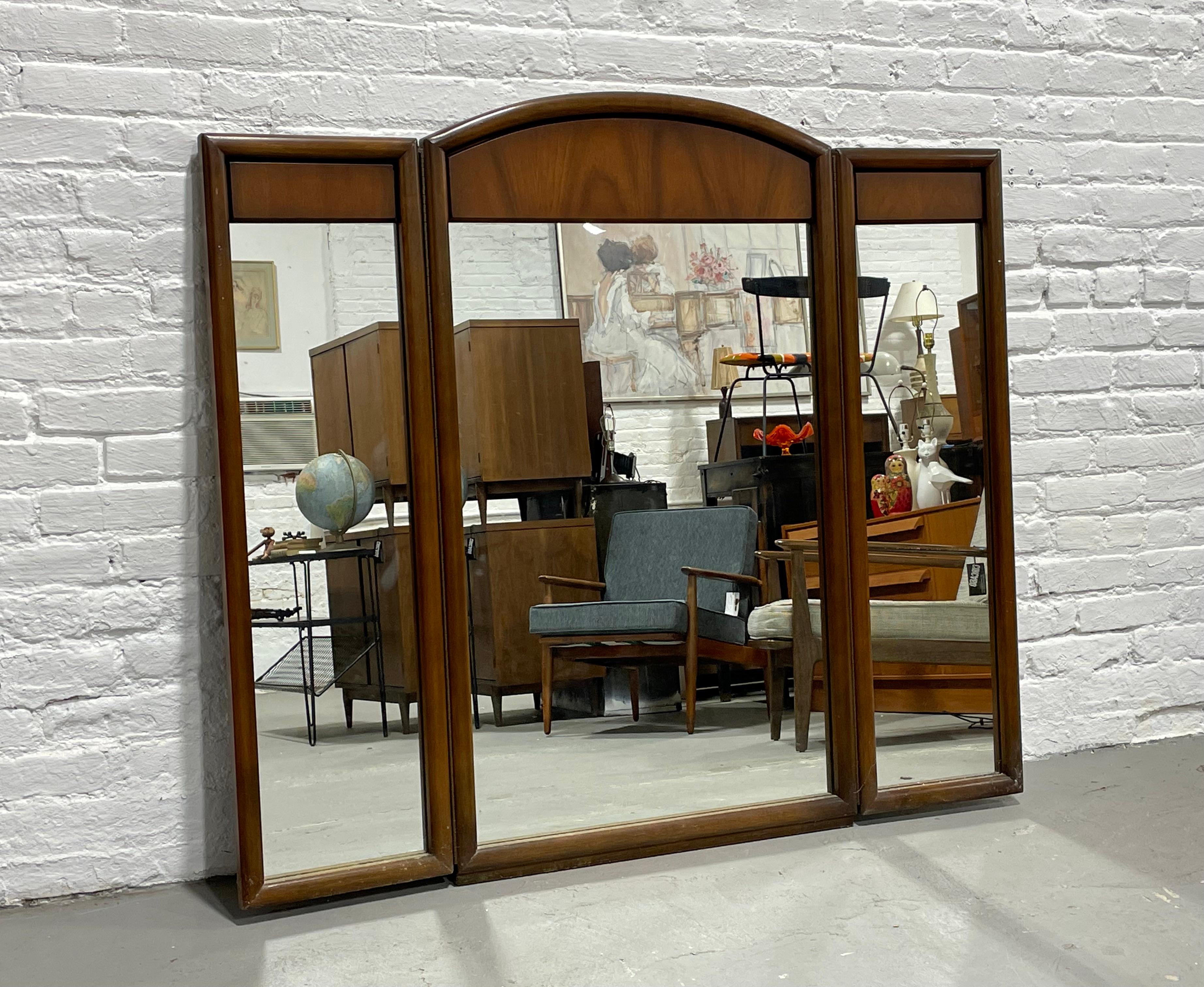 Large Mid-Century Modern walnut three panel mirror, c. 1960s. The glass is crystal clear and the walnut framing is in lovely condition. Each side mirror can be moved and sits on piano hinges. Sturdy and handsome mirror that will add a stunning
