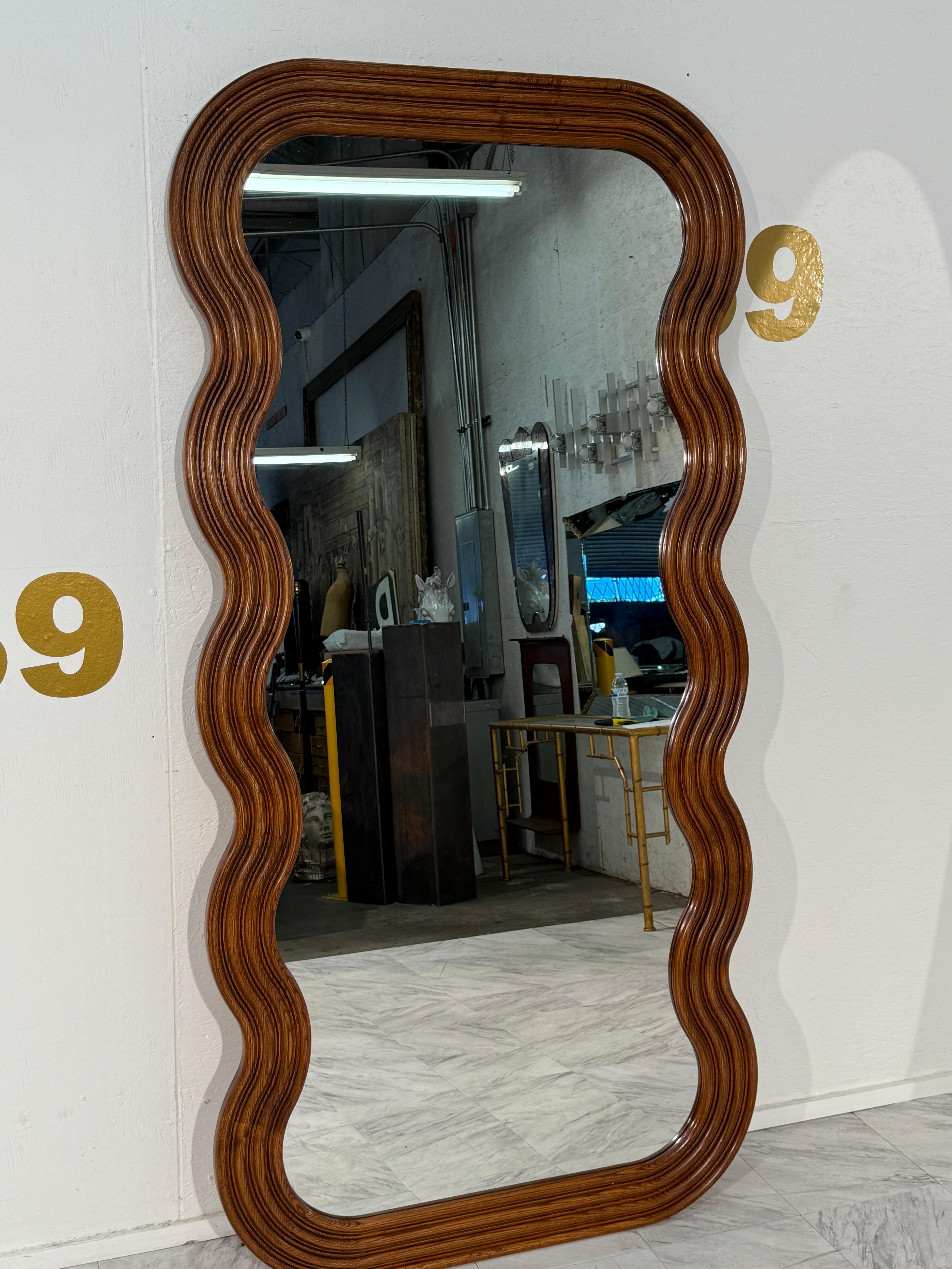 Un sorprendente specchio da terra in stile Mid-Century Modern con una scultorea cornice ondulata in Oak. Le curve organiche del design ammorbidiscono la silhouette rettangolare, conferendo al pezzo un'estetica fluida e moderna. Realizzata in rovere