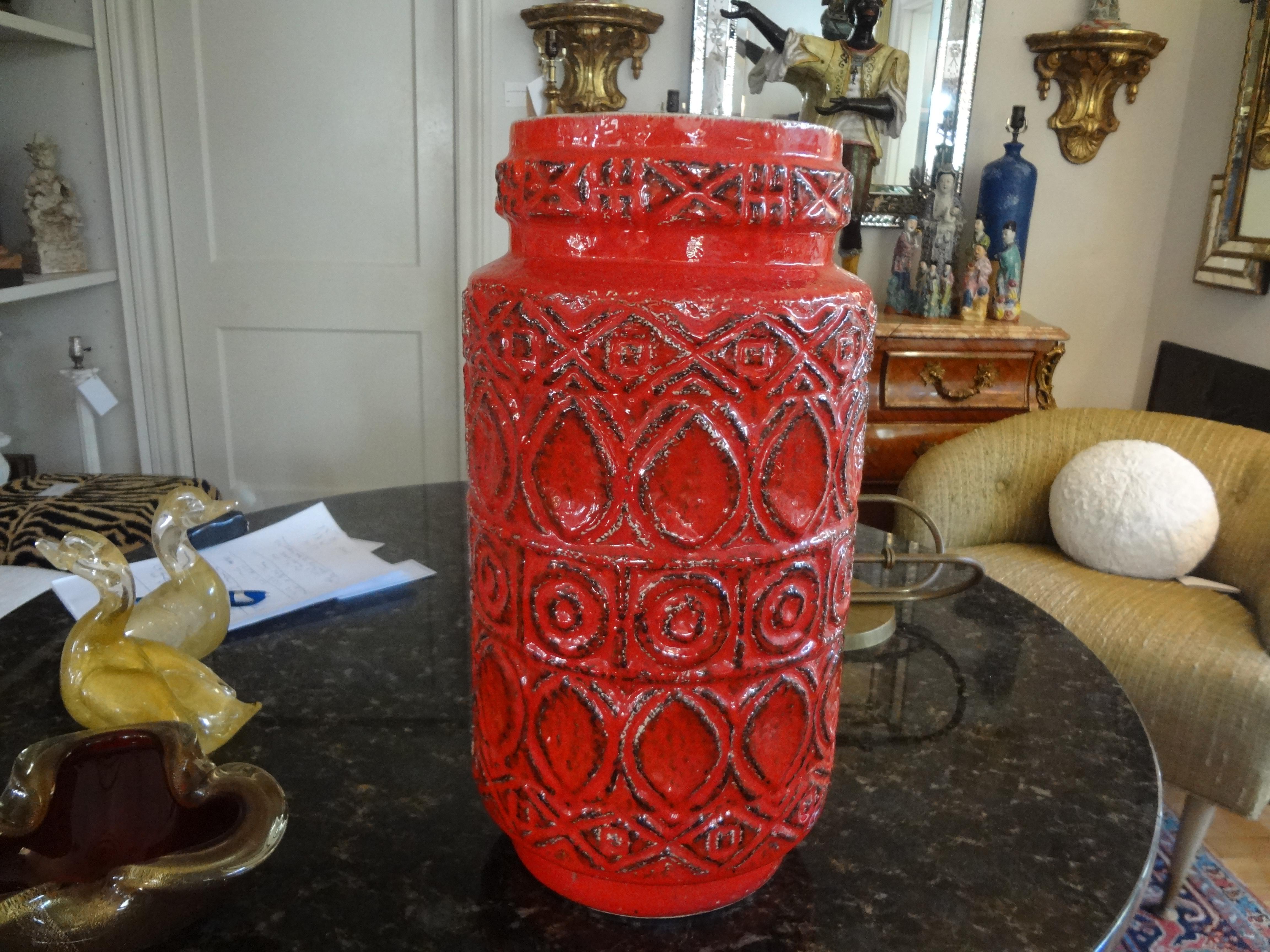 Large Mid-Century Modern West German glazed pottery vase.
Stunning large Mid-Century Modern West German tomato red glazed pottery vase with a great stylized geometric decoration.