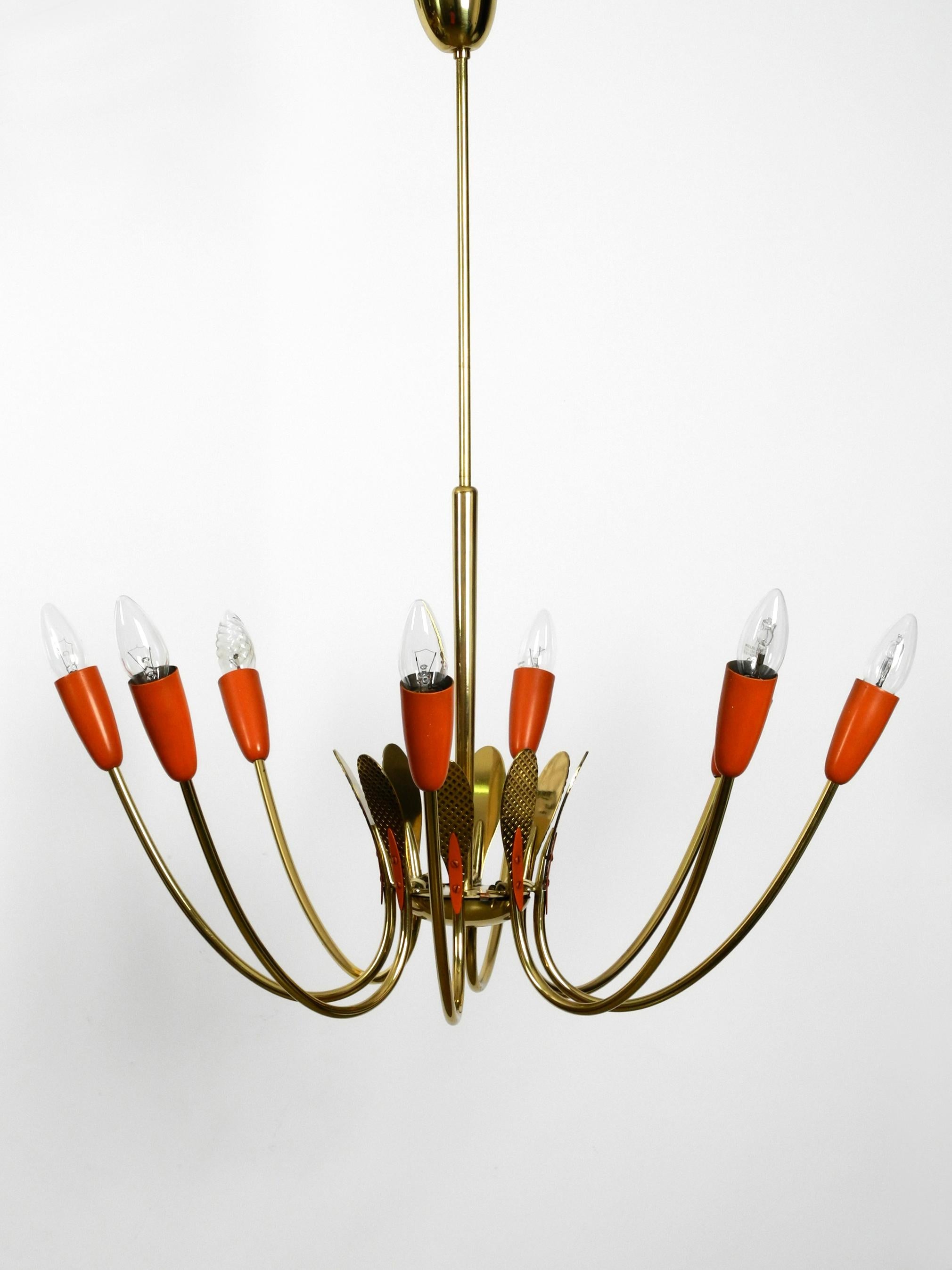 Very rare large Mid-Century Modernist Sputnik
ceiling lamp made of brass with metal cones.
Very nice Classic 1950s atomic design in good condition with great patina.
Brass frame and canopy, metal cones are painted in brick red color.
The brass