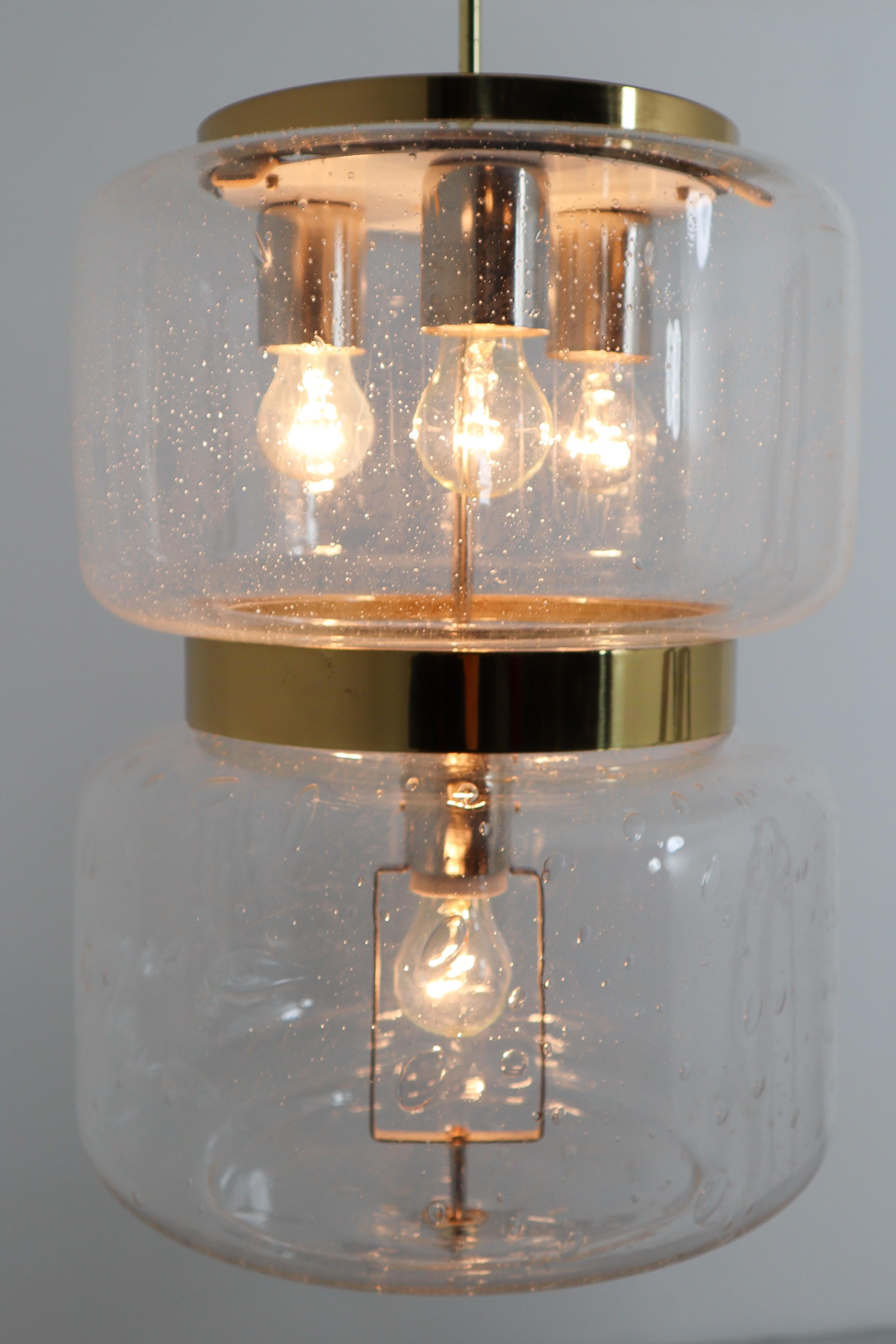 Large European midcentury pendant, Austria, 1960s. The hand blown clear glass contains air bubbles of varying sizes and density that create a wonderful light effect. These lamp will contribute to a luxurious character of the (hotel-restaurant-bar)