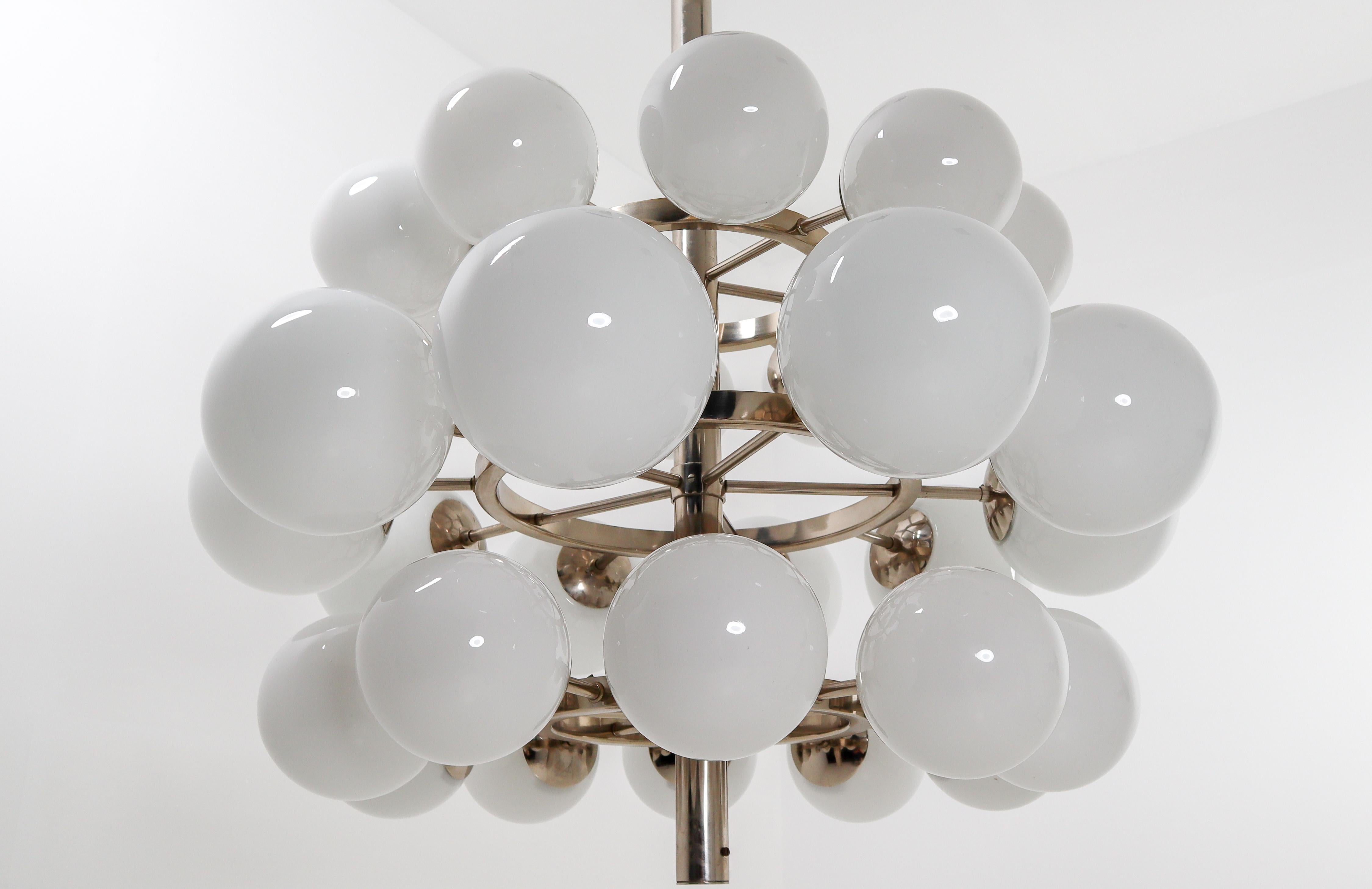 Mid-Century Modernist extreme large chandelier with 30 hand blown opaline glass globes. The fixture is made of metal with a chrome-brass patina. Therefore an interesting color is visible on the metal. Thirty opaline glass globes are placed over