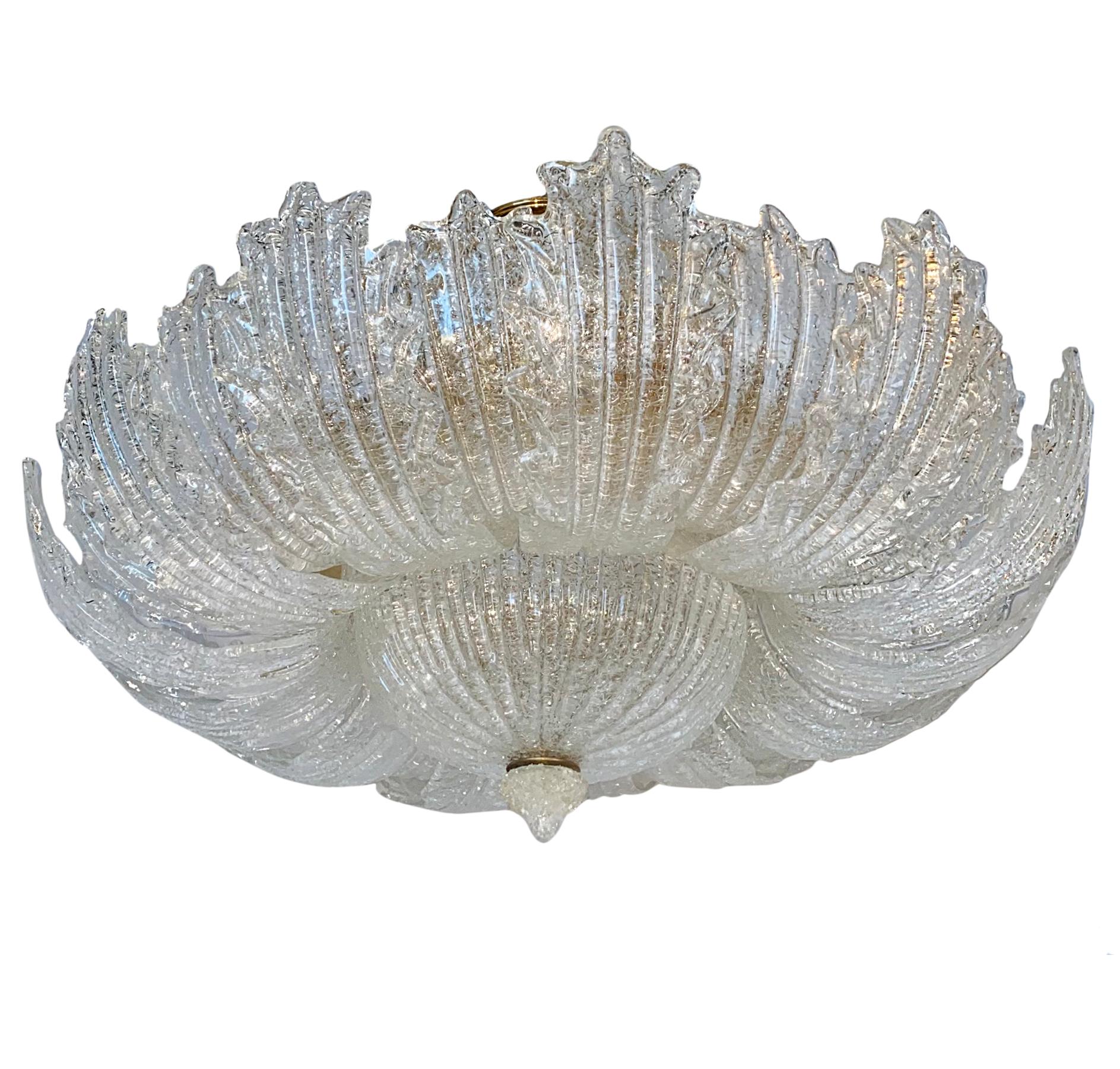 A circa 1950's glass chandelier fixture with molded glass leaves and fourteen interior lights.

Measurements:
Diameter: 32