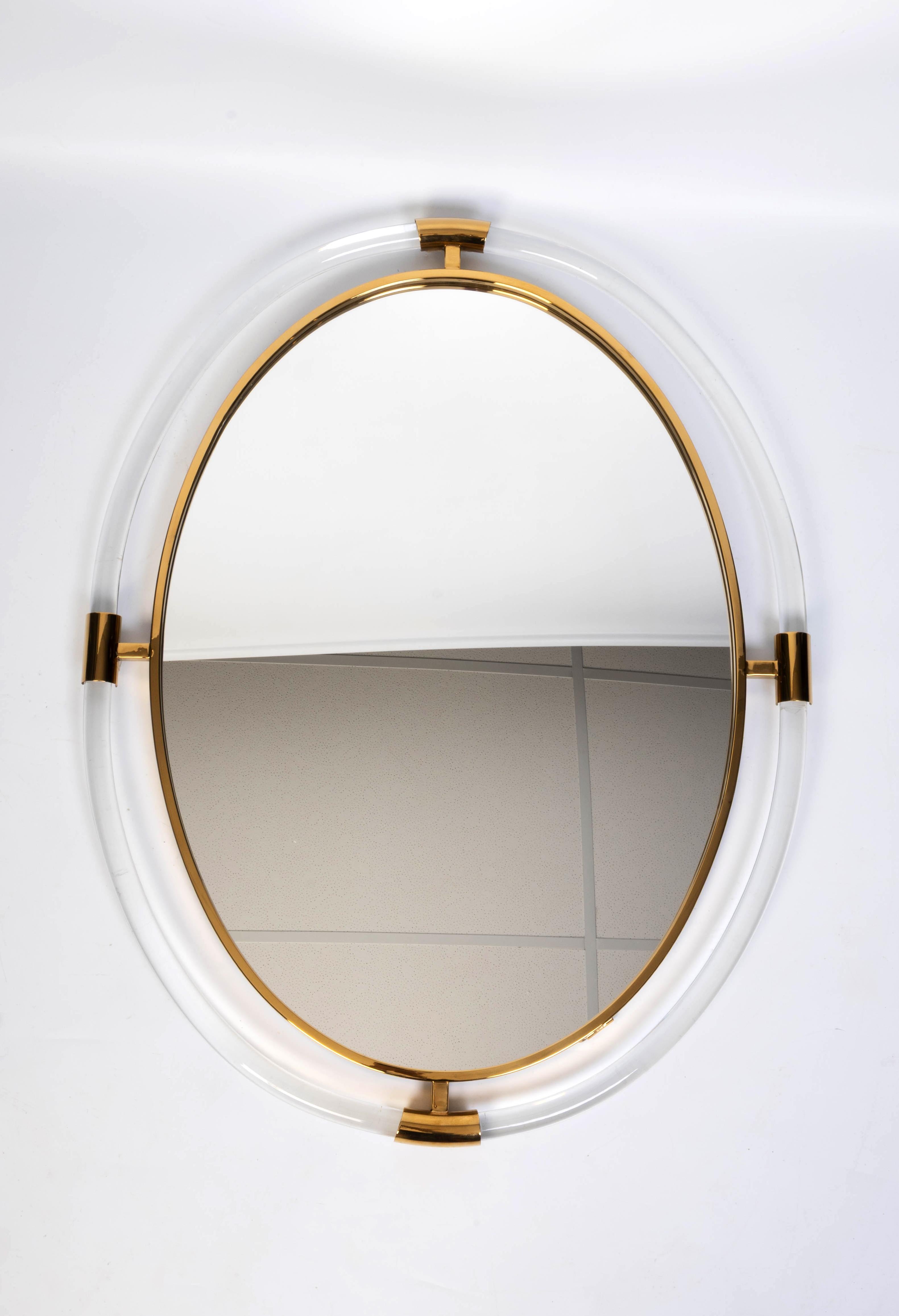 Large Mid Century Oval Lucite And Brass Mirror 

In very good condition.