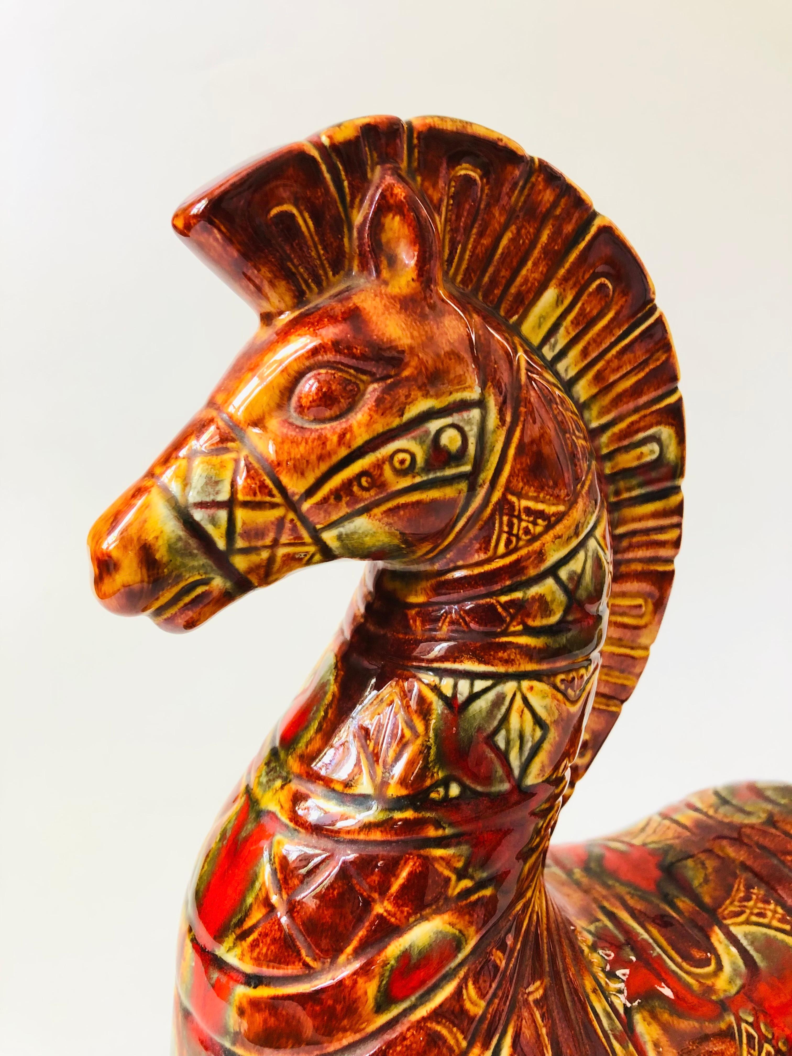 A large mid century ceramic art pottery ram in the style of Bitossi. Red-orange and yellow glazes with an intricate carved pattern to the surface in a mid century stylized form. A great statement piece.

