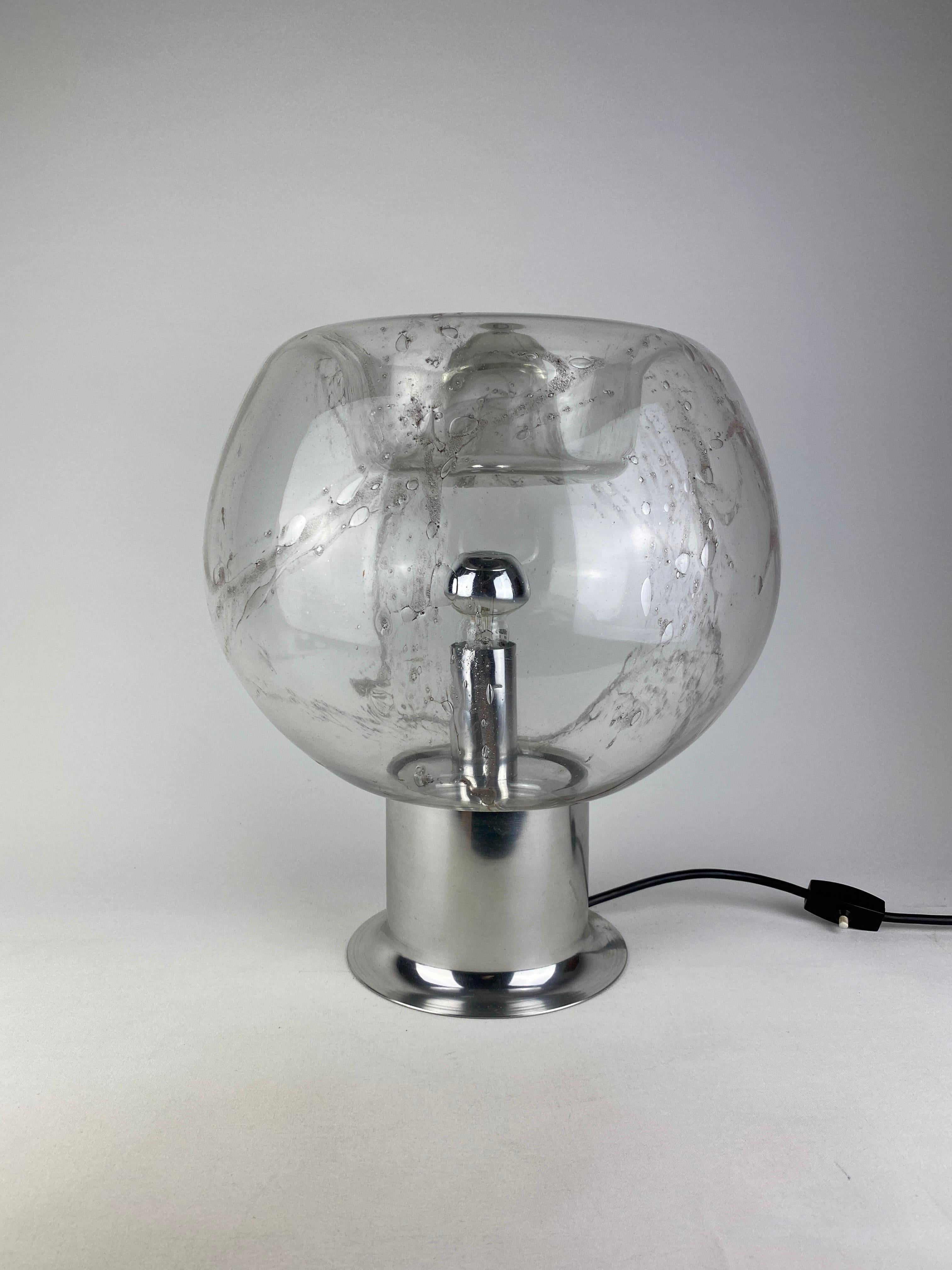 Wow, what a find! This very large and rare glass table lamp is made by the German makers Doria Leuchten in the 1970's This handmade glass is beautifully done with a sculptural shape on the top. 

It's like a piece of art because of the work and