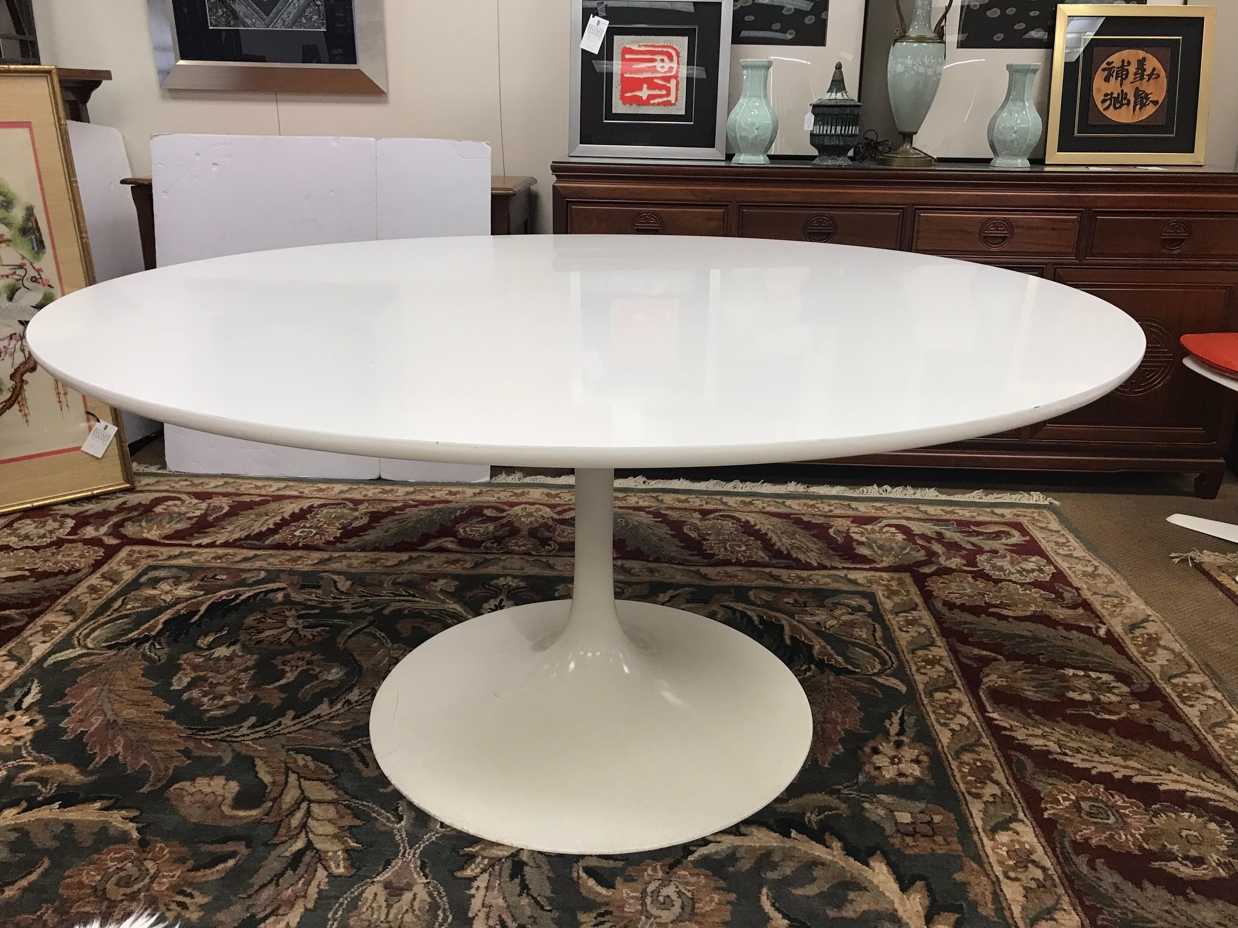 Large round midcentury white tulip table in the manner of Eero Saarinen. Features a white fiberglass base with a round white high gloss top. Manufactured by famed Burke Industries, Texas, USA.