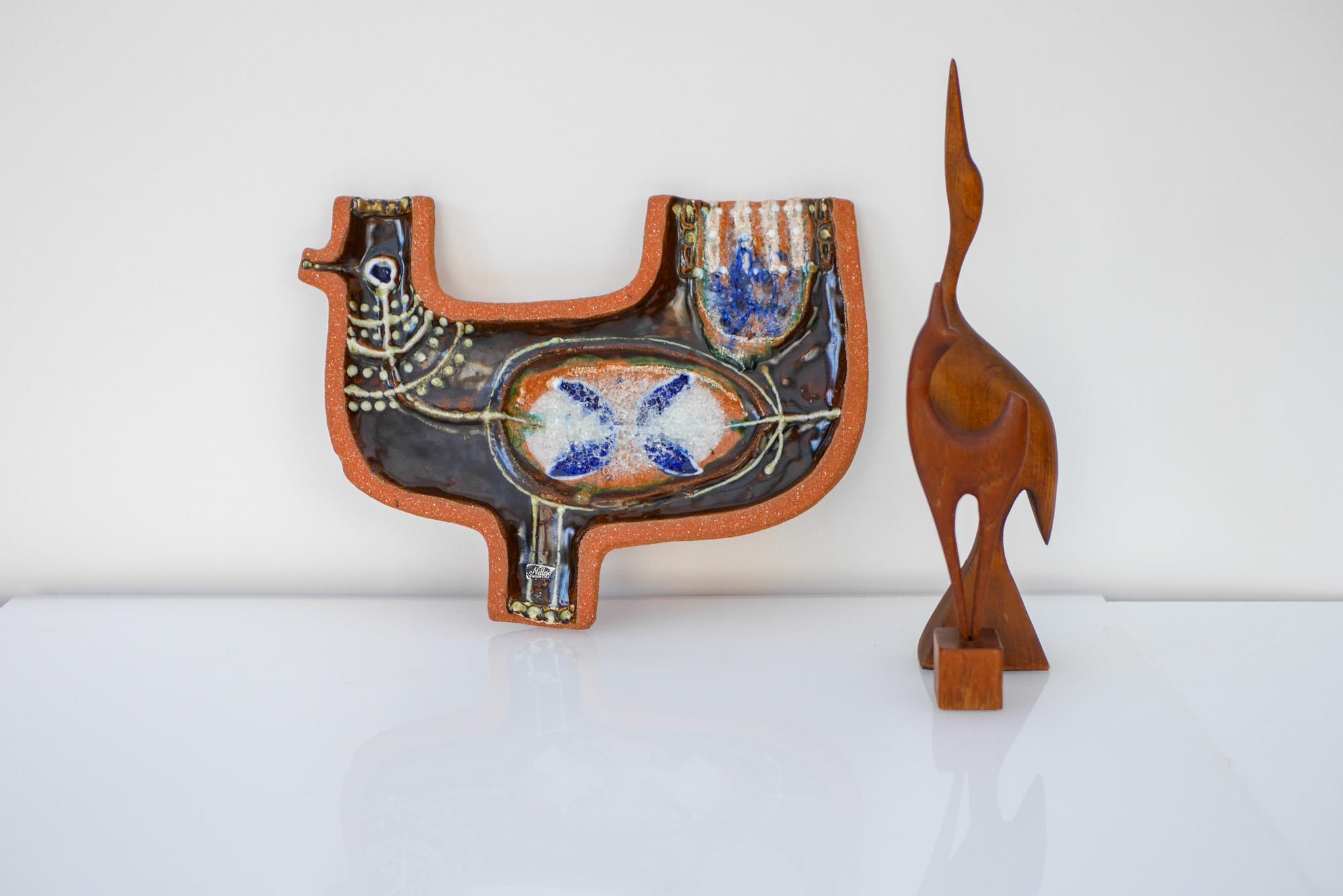 Mid-century modern signed Scandinavian art pottery wall decoration. This ceramic piece is known as “the Hen” and has a very 70's feeling to it and it depicts an abstract hen, in really nice color, warm grey with hints of blue combined with warm