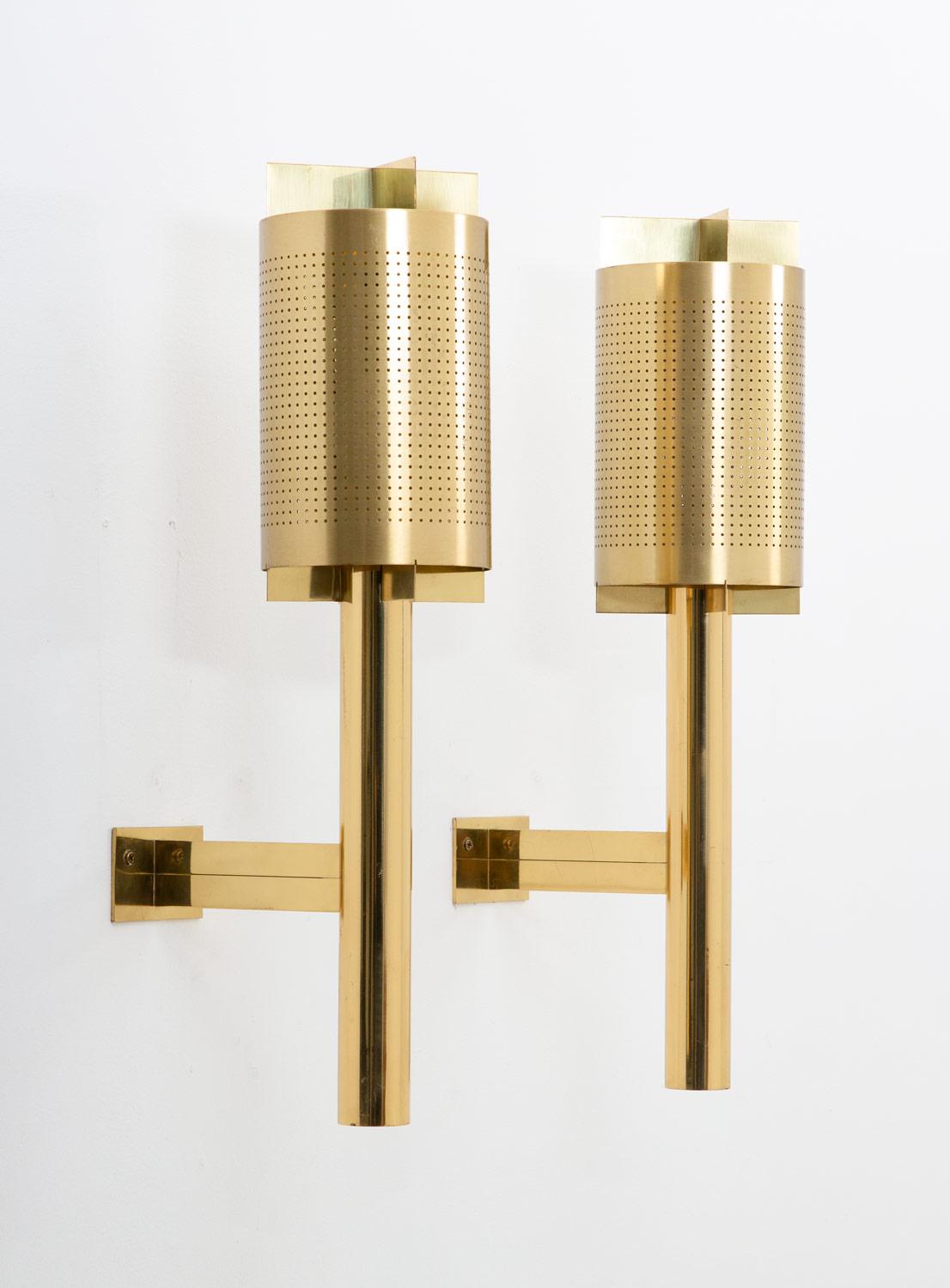 Rare midcentury wall sconces, produced in Sweden, possibly by Westal.
These lamps are made of solid, thick brass. They feature one light source, hidden by a perforated brass shade, that spreads the light in an amazing way when lit.
Condition:
