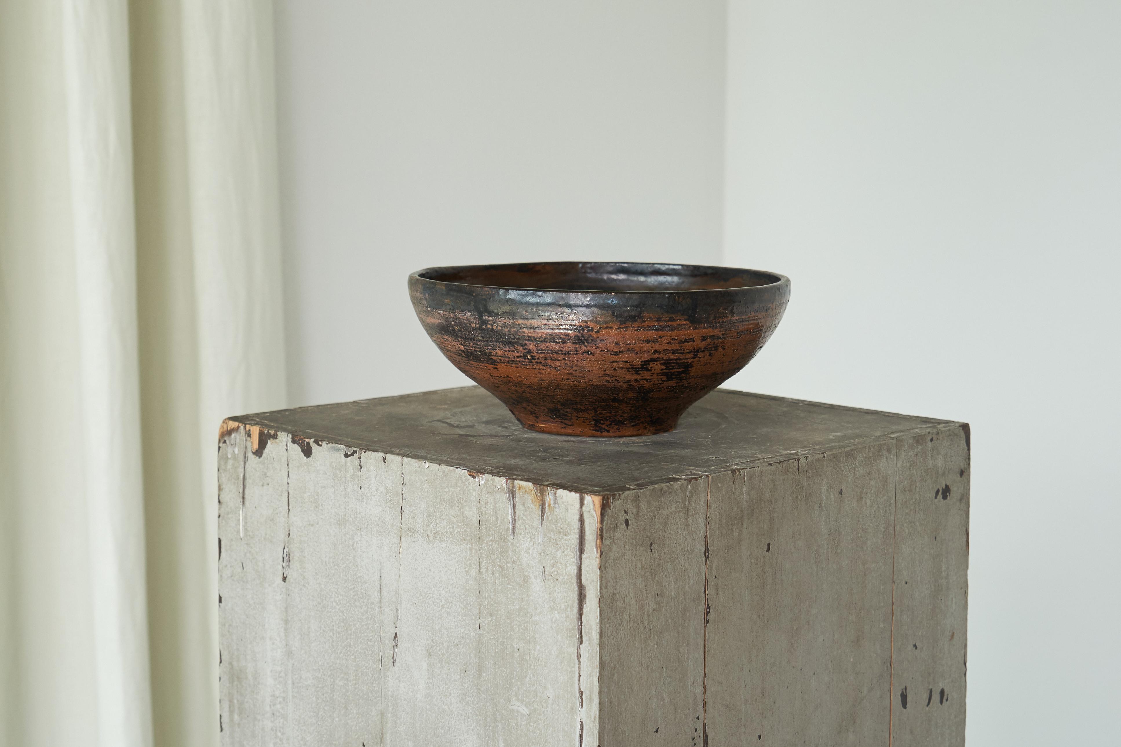 Large Mid Century Studio Pottery Bowl 1960s

This is a beautiful large studio pottery bowl or centerpiece. Colors shift from brown to red, orange and blue. Very interesting and tactile surface and crafted with a keen focus on material and texture,