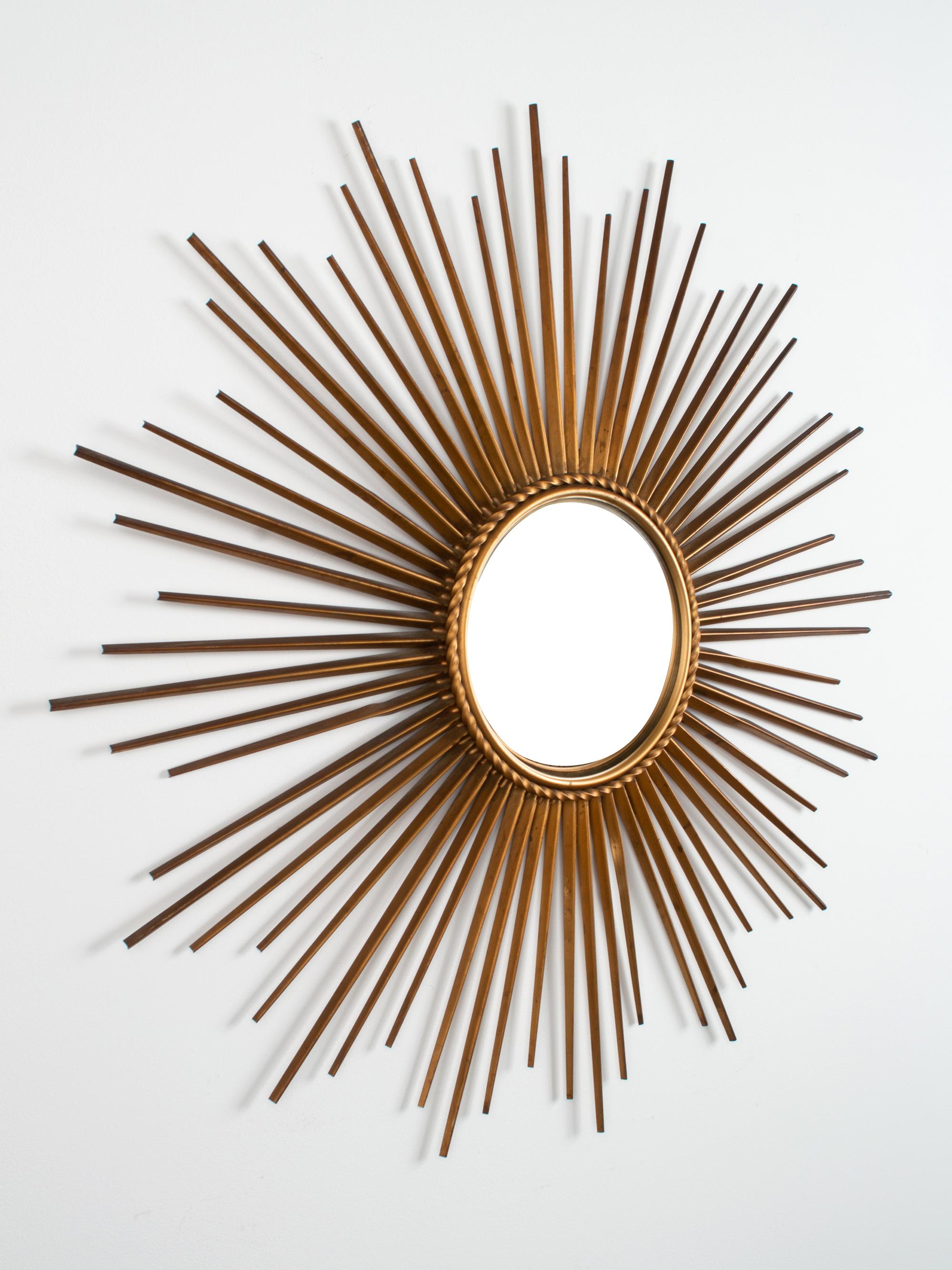 Large bronze metal sunburst mirror by Chaty Vallarius, France, circa 1950.
Very good condition consistent with age. Slight twists to three stems.