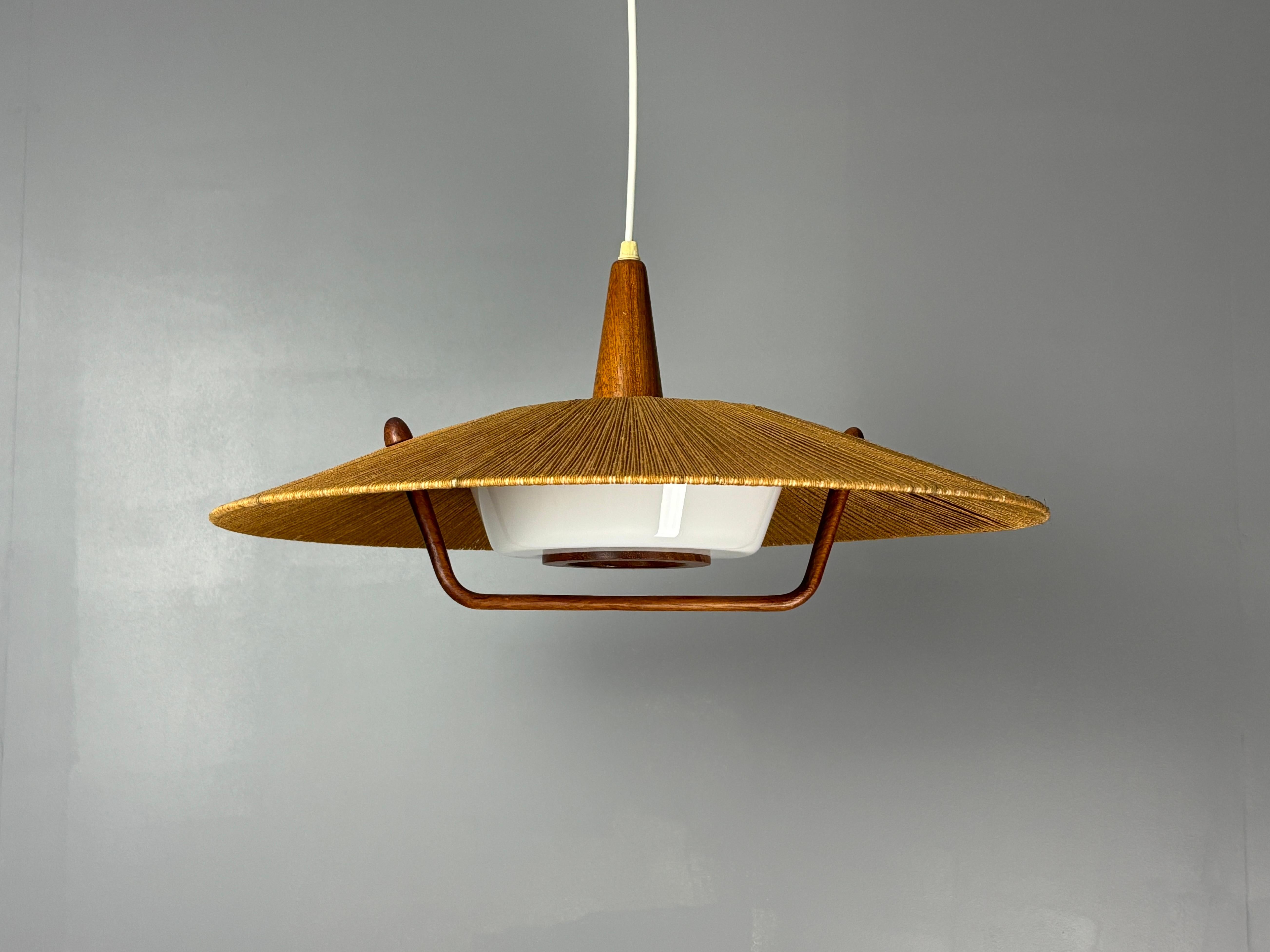 Large sisal and teak pendants by Temde, 1960s-1970s. We actually have two pieces of this model in stock. The other one is listed under the same name and has a slightly lighter sisal rope shade. Both lamps are in great vintage and original condition.